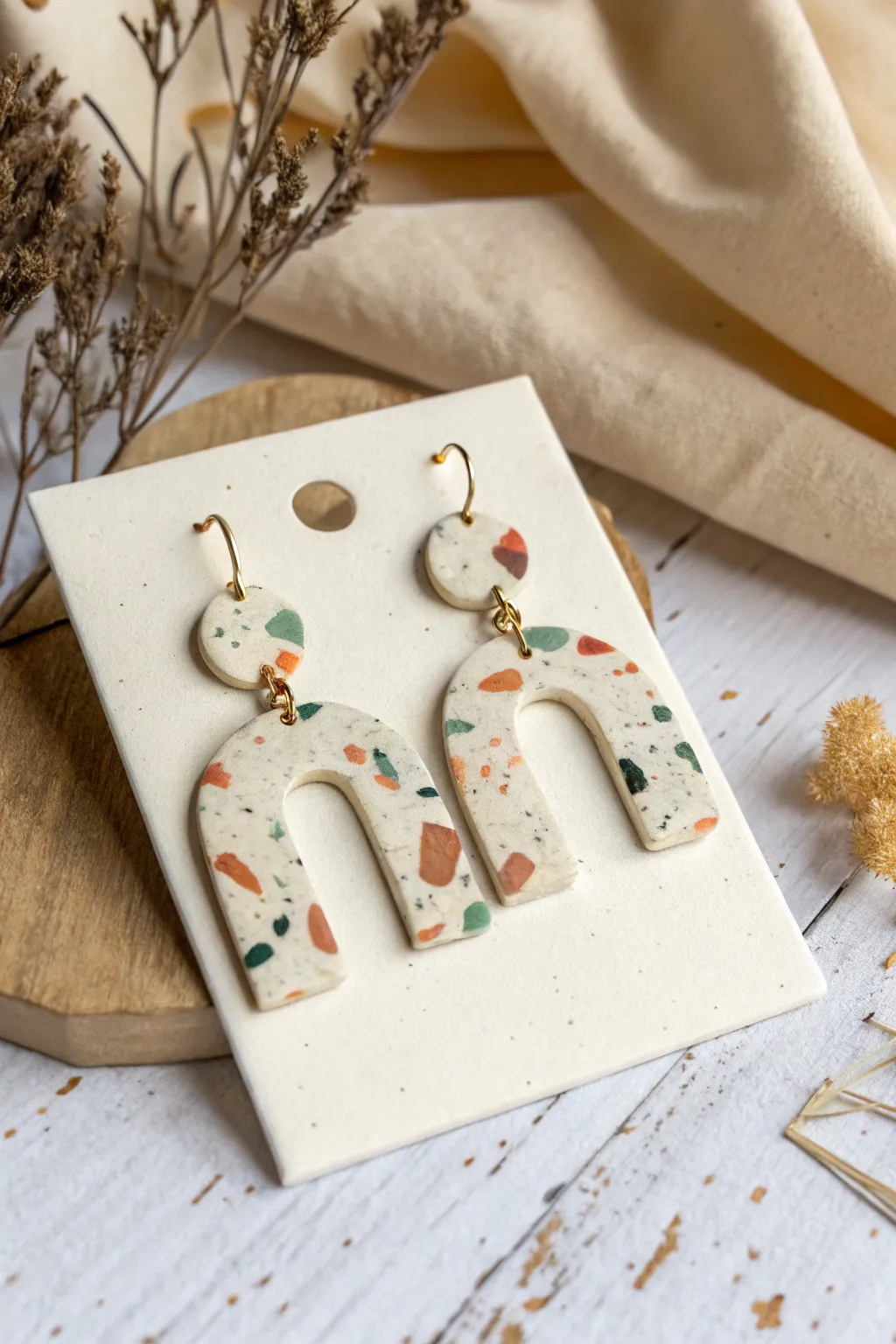 Beginner terrazzo polymer clay earrings in arch shapes, chunky confetti specks, clean minimalist look.