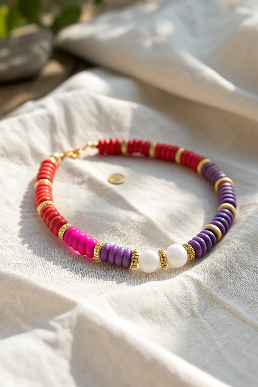 Preppy rainbow clay bead bracelet in perfect color order with white breaks and gold spacers.