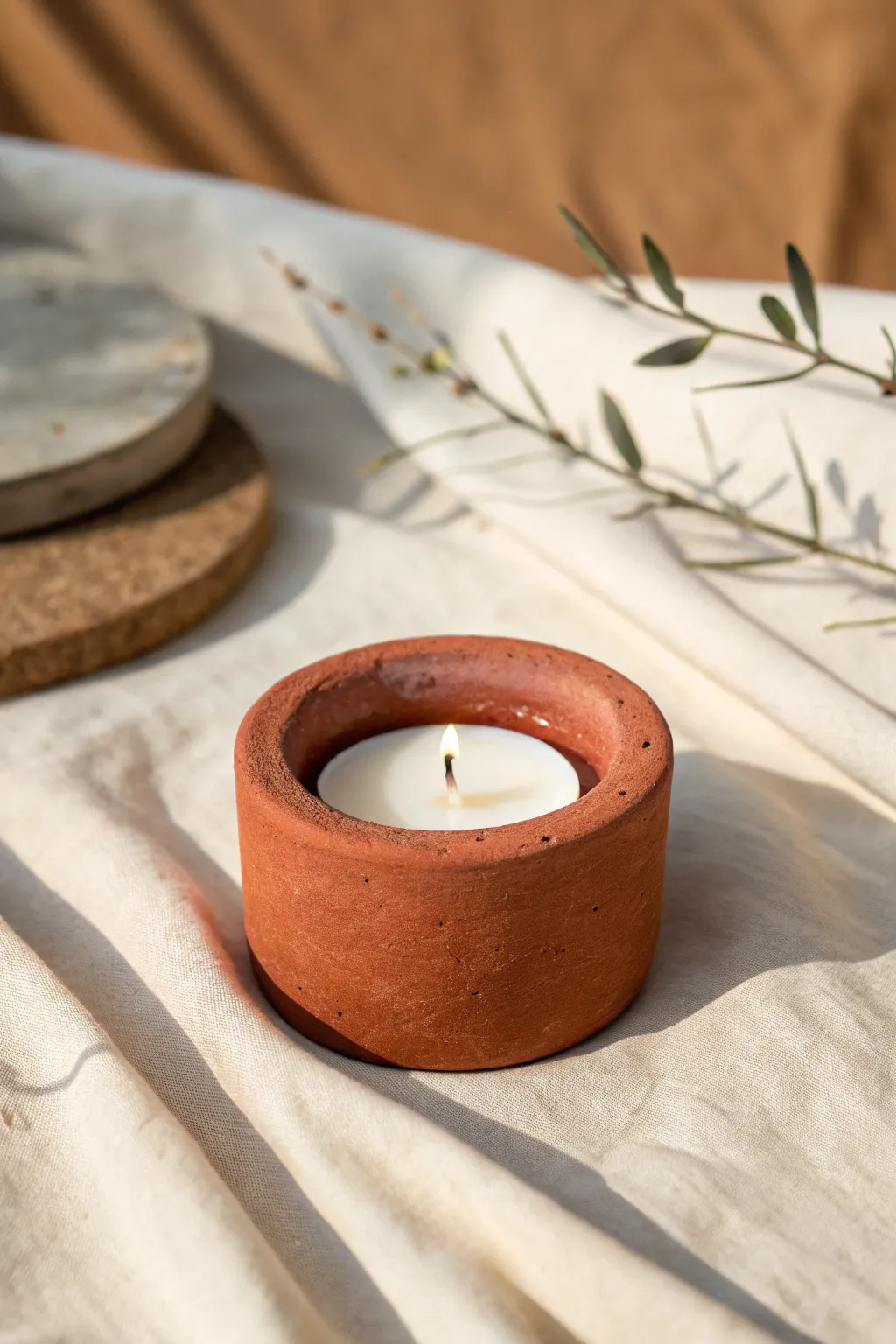 Chunky matte terracotta tea light holder with cozy handmade texture and clean minimal styling