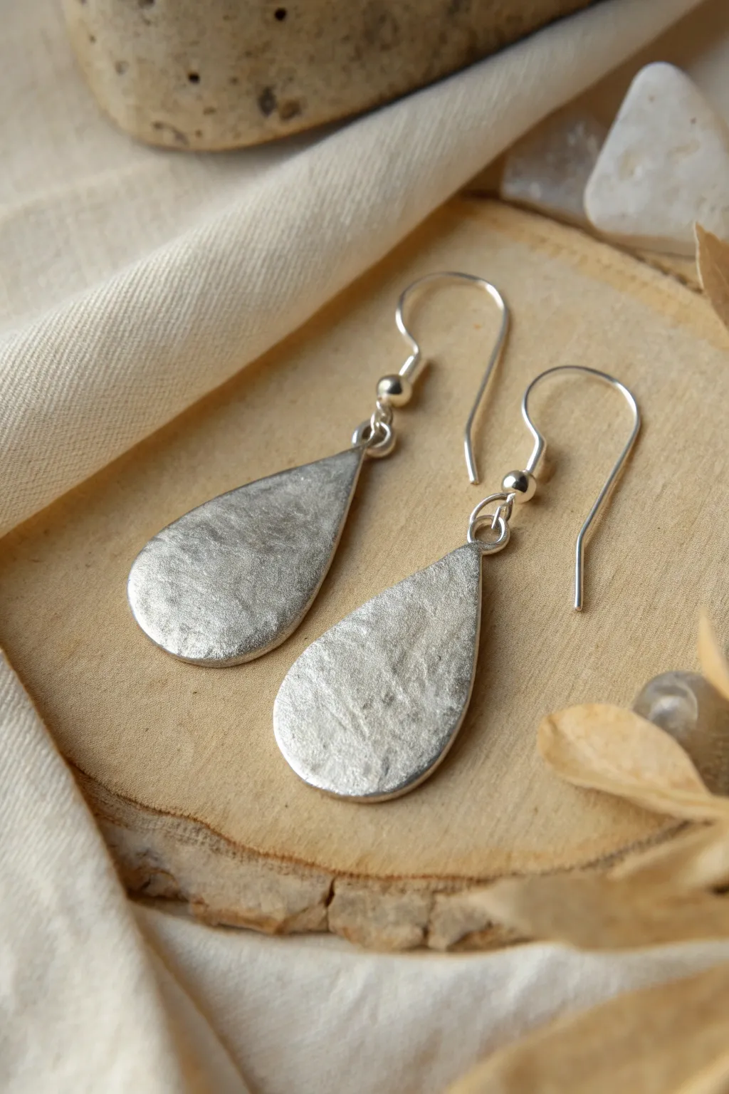 Organic teardrop silver clay dangles with brushed texture and softly oxidized edges