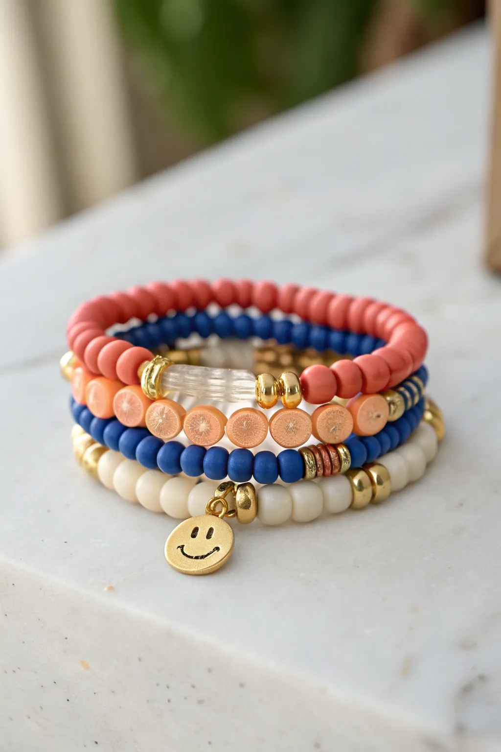Smiley charm centerpiece stack with bold clay discs and gold accents, minimal yet playful.