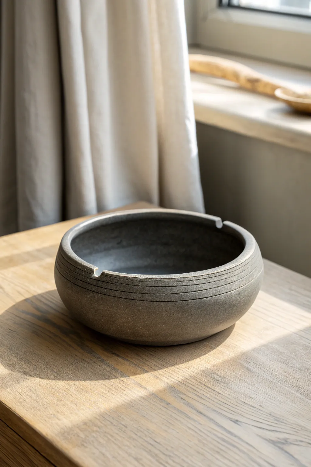 Extra-deep charcoal clay ashtray with four notches, minimalist and bold with handmade texture.