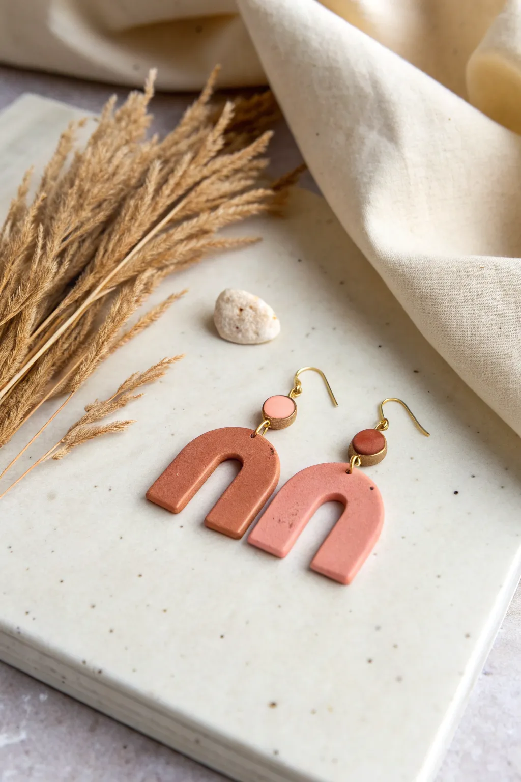 Minimal air dry clay arch earrings in matte terracotta and blush, a chic cutout DIY finish.