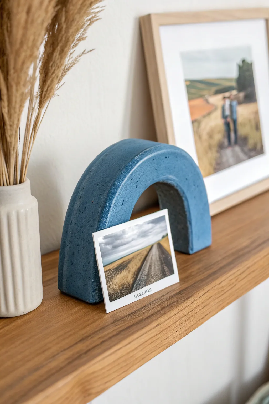 Handmade air dry clay photo holder in bold cobalt, a sweet pottery date night keepsake.