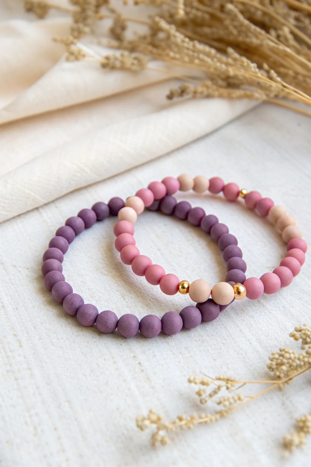 Soft pastel ombre BFF clay bead bracelets fading from lavender to blush in perfect matching order