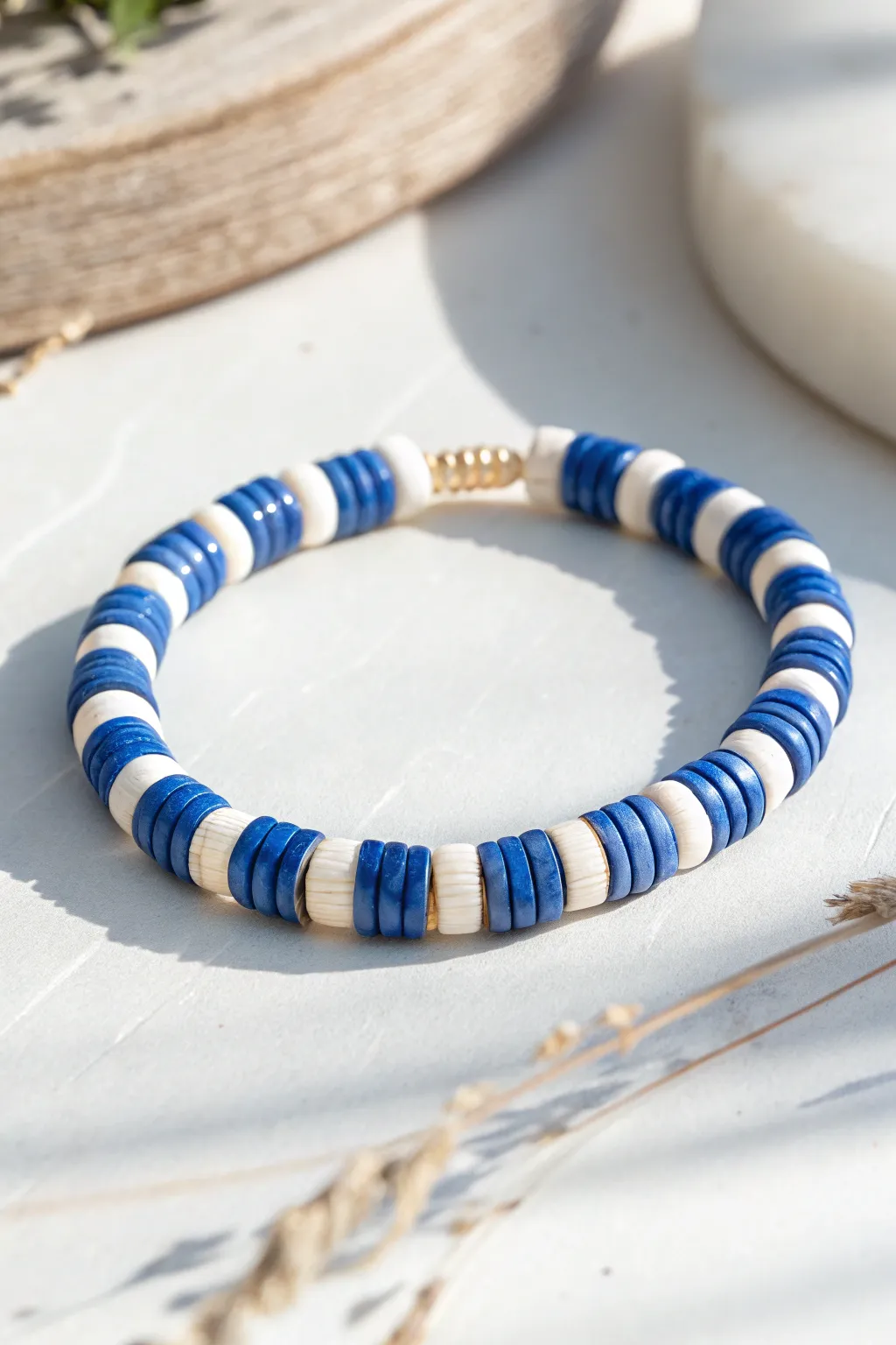 Blue and white striped heishi bracelet in a clean circle, minimal Nordic style with boho charm.