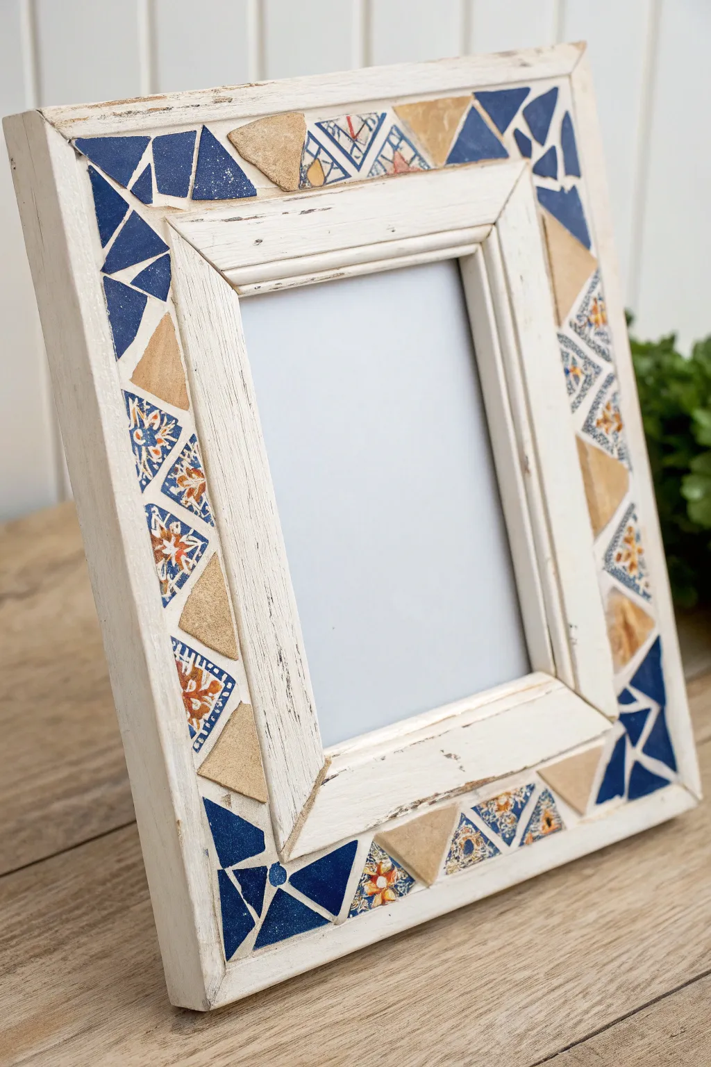 Broken plate art made simple: a chic frame with china shard corners and soft grout, cozy and modern.