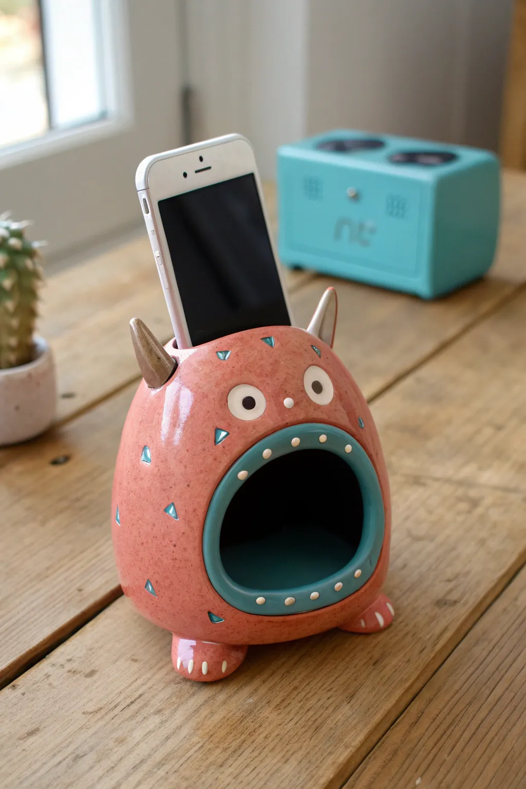 A bold coral monster mouth phone amplifier that looks like it is singing, simple and charming.