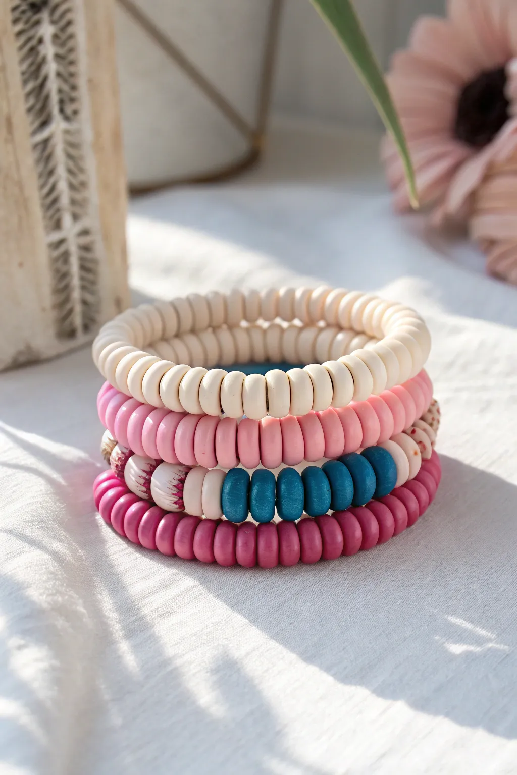 Monochrome pink heishi stack with one bold statement bead for effortless minimalist boho charm.