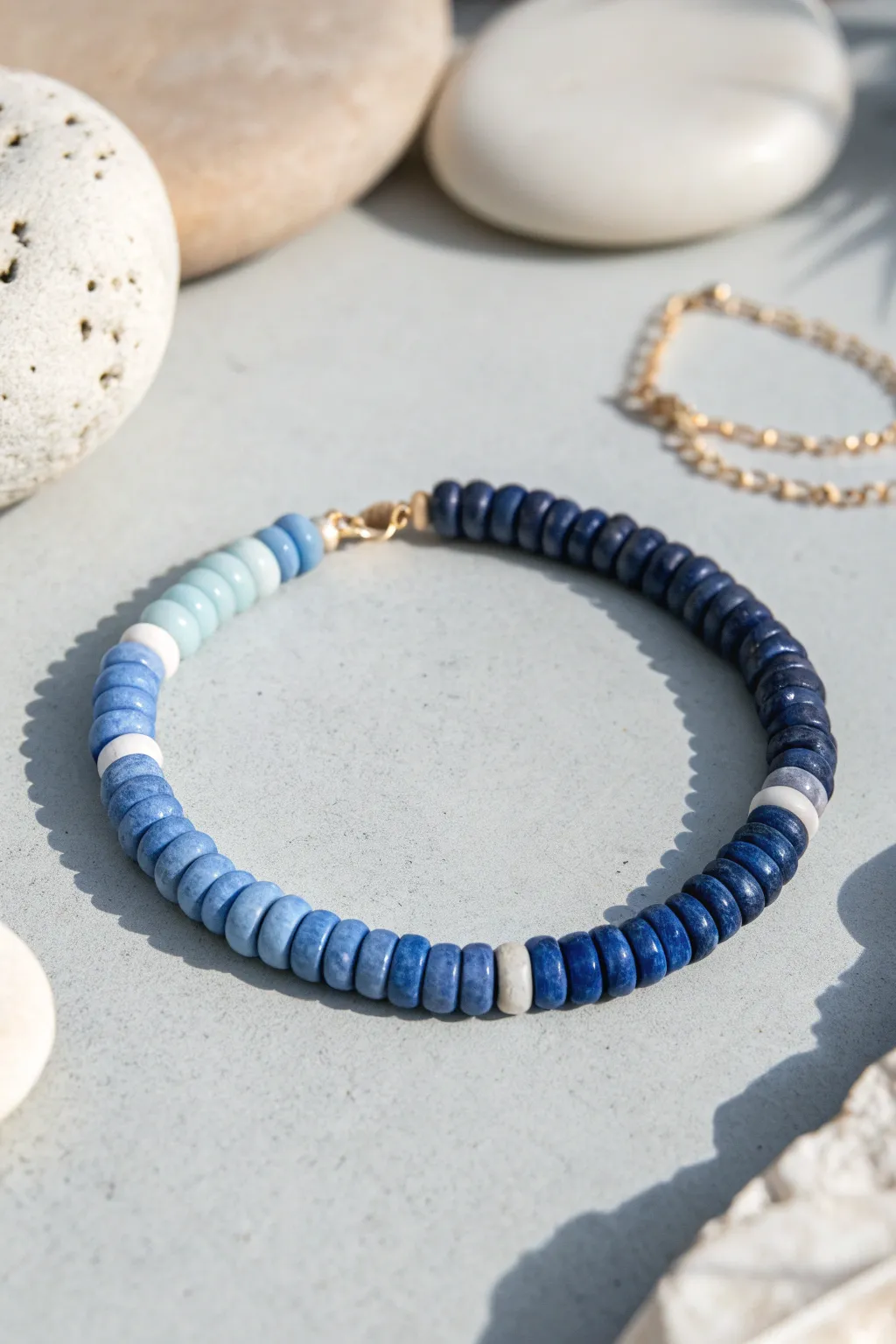 Cool blues ombré heishi bracelet fading from icy sky to deep navy, minimalist and handmade.