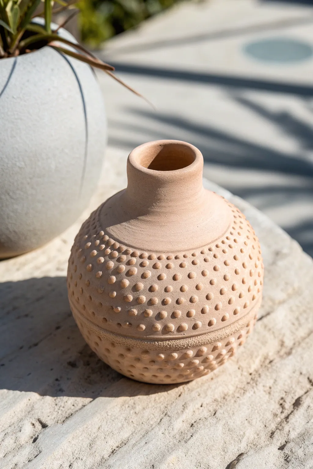 Dot-and-dash stippling adds a playful gradient texture to a simple bud vase for cozy, modern pottery decor.