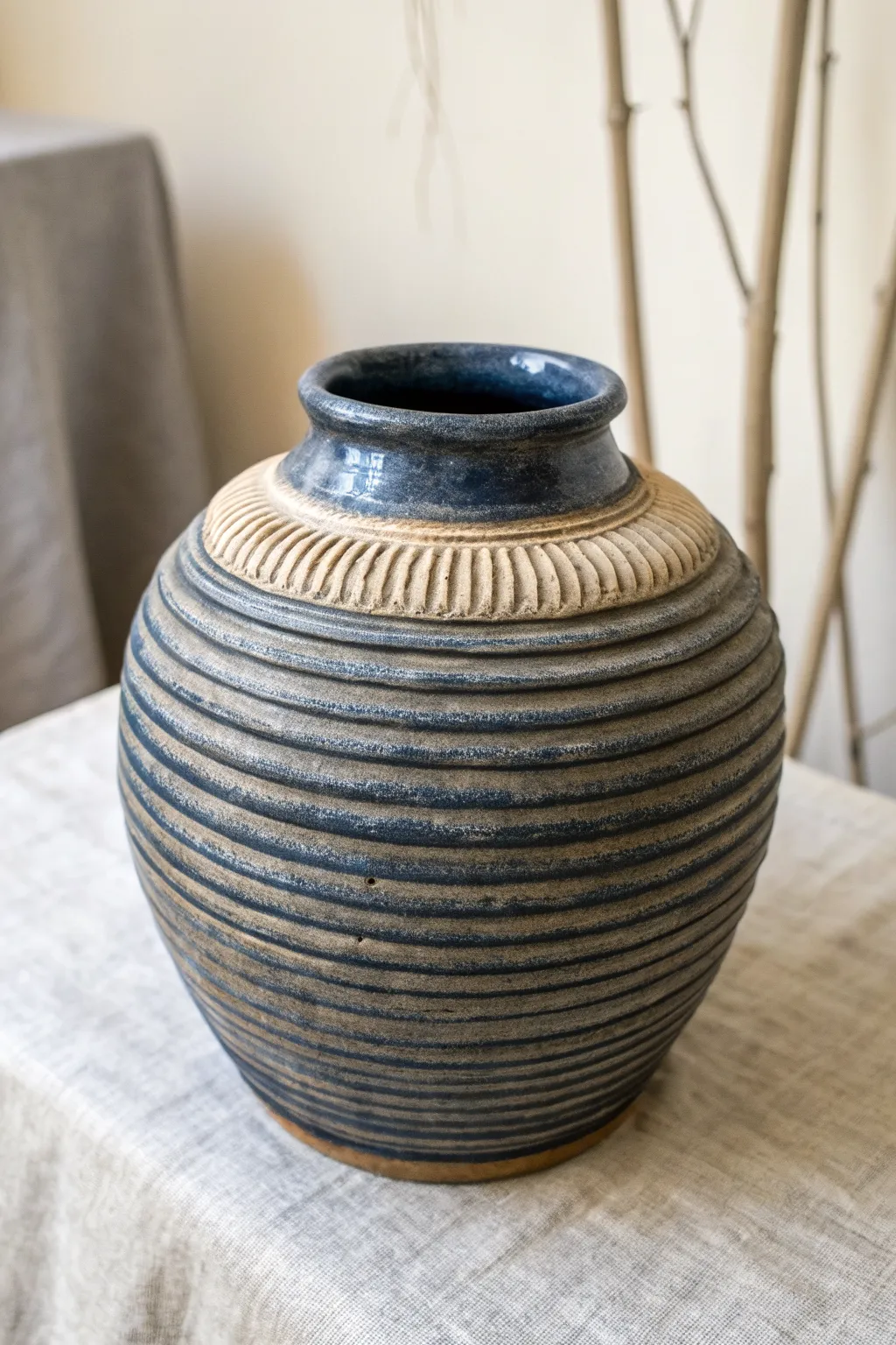 Corrugated coil jar with dramatic dark wash, minimalist boho styling, handcrafted texture.