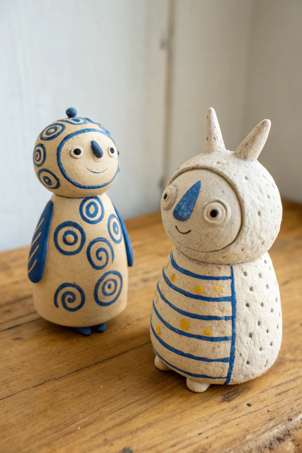 Two tiny clay creatures made from five simple shapes, perfect for a playful date challenge.