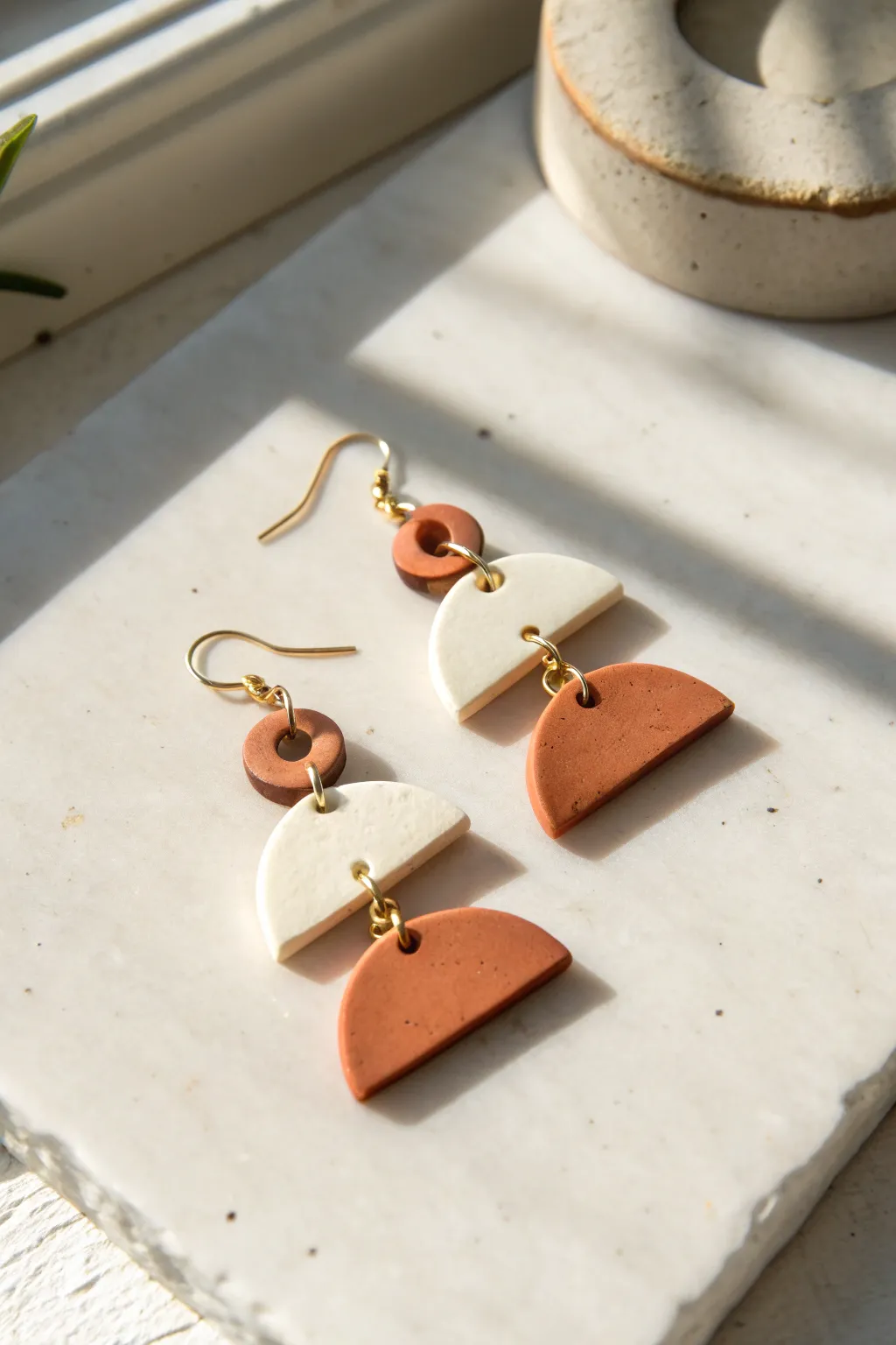 Mini half-moon and U-shape clay earrings in soft neutrals for clean, modern boho style.