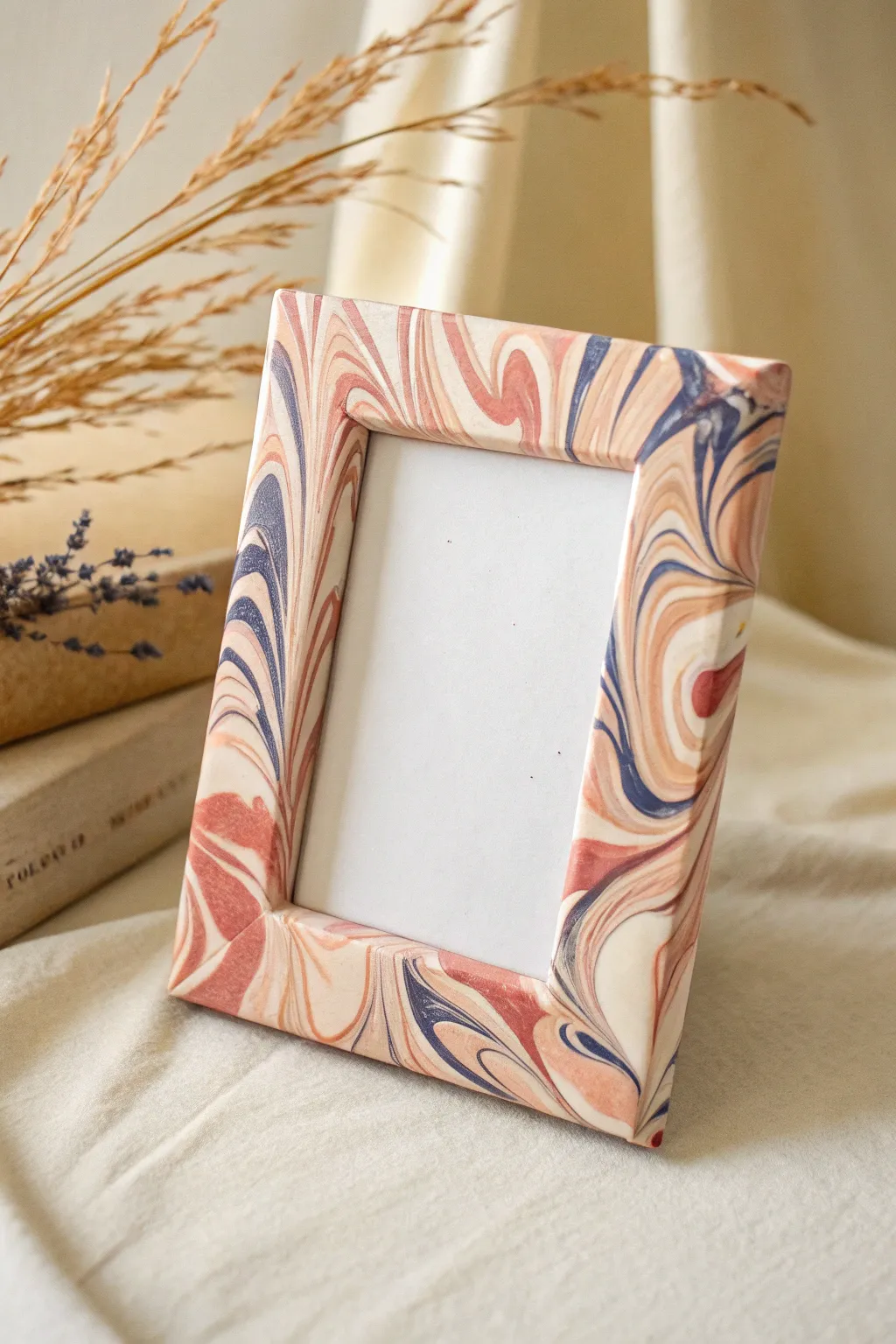 Marbled swirl clay frame in blush, terracotta, and ivory for an easy modern-boho statement.