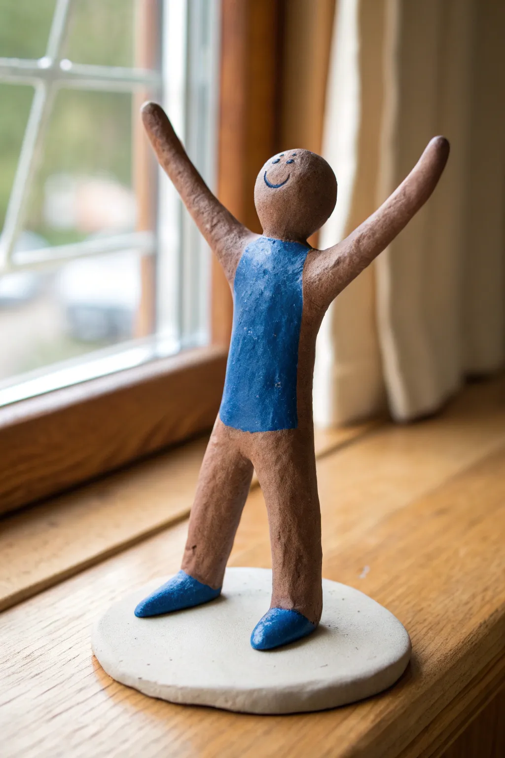 Let posture speak: a simple clay gesture figure capturing emotion in a bold minimalist pose.