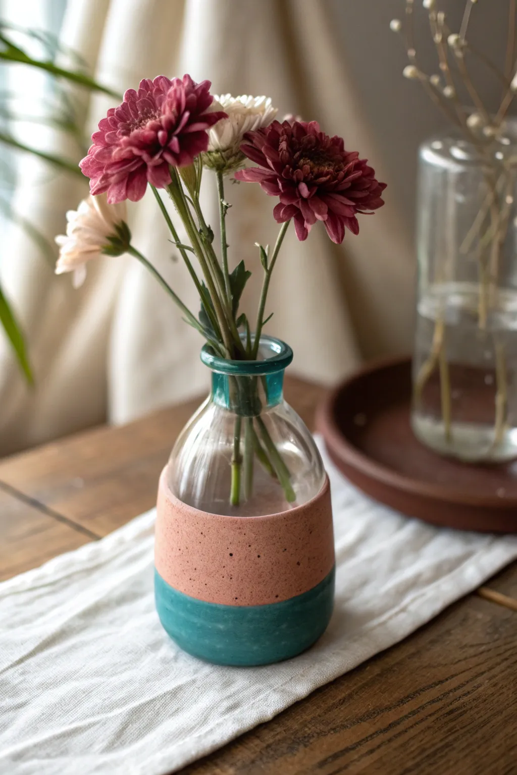 Beginner-friendly mini bud vase with glass insert, simple clay cover, bold single stem.
