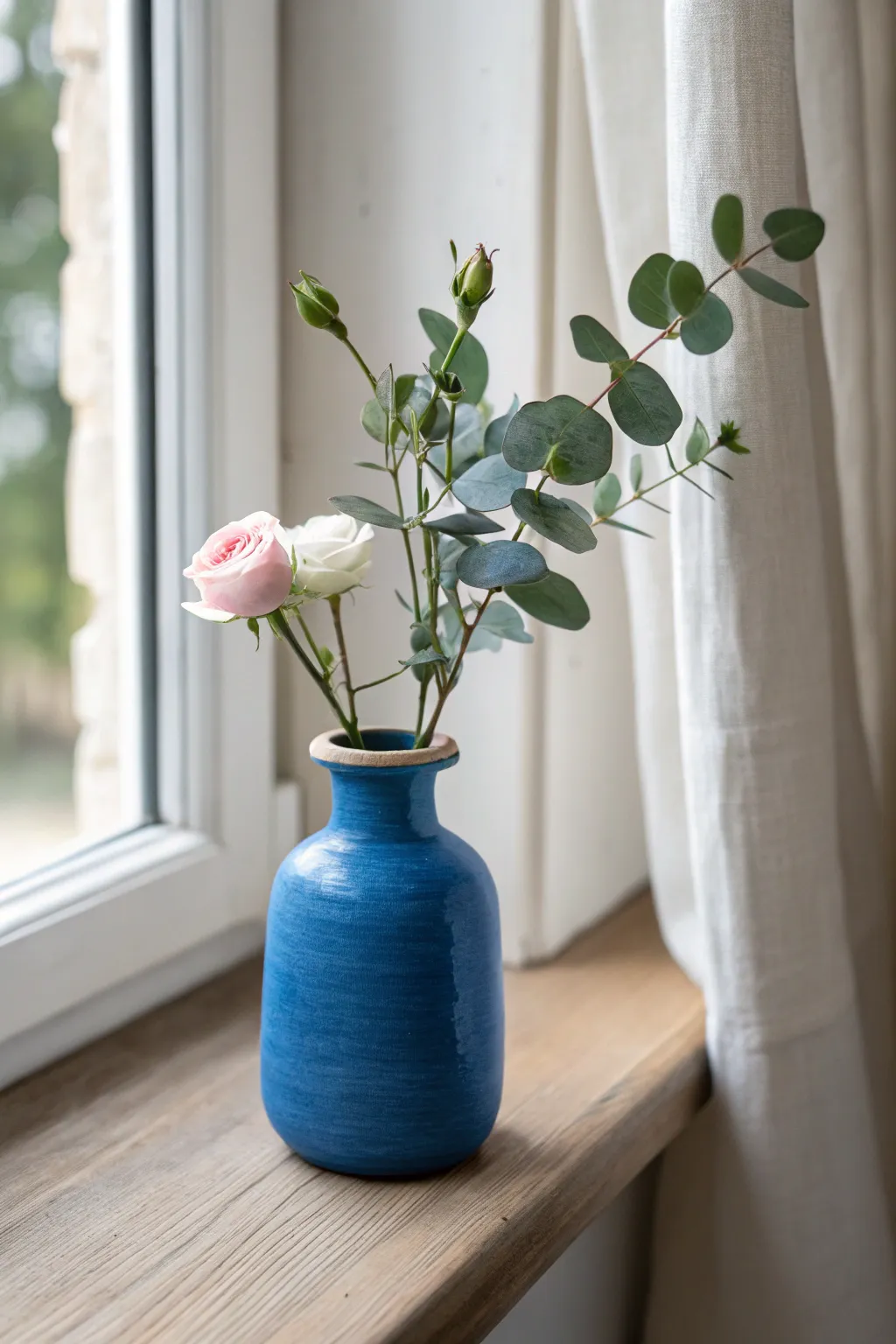 Minimal mini bud vase with fresh stems, a heartfelt clay gift for mom in calm Nordic style.