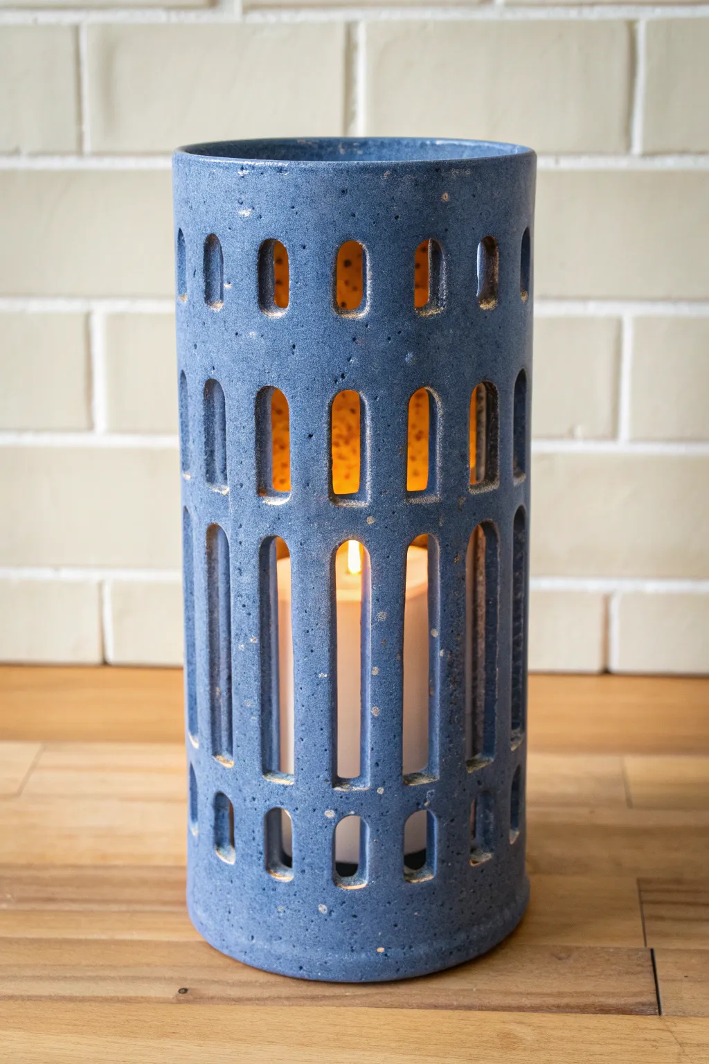 Arched window clay luminary glowing like a tiny lantern, minimalist and warmly inviting.