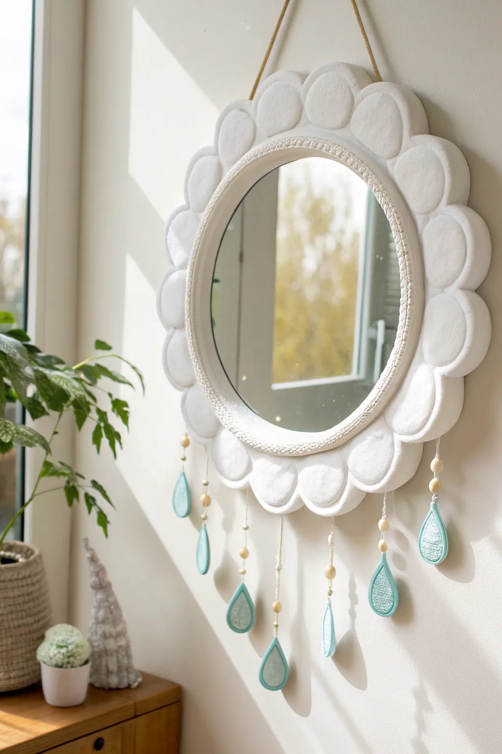 Whimsical cloud clay mirror with puffy raindrops, minimalist boho charm in soft blues.