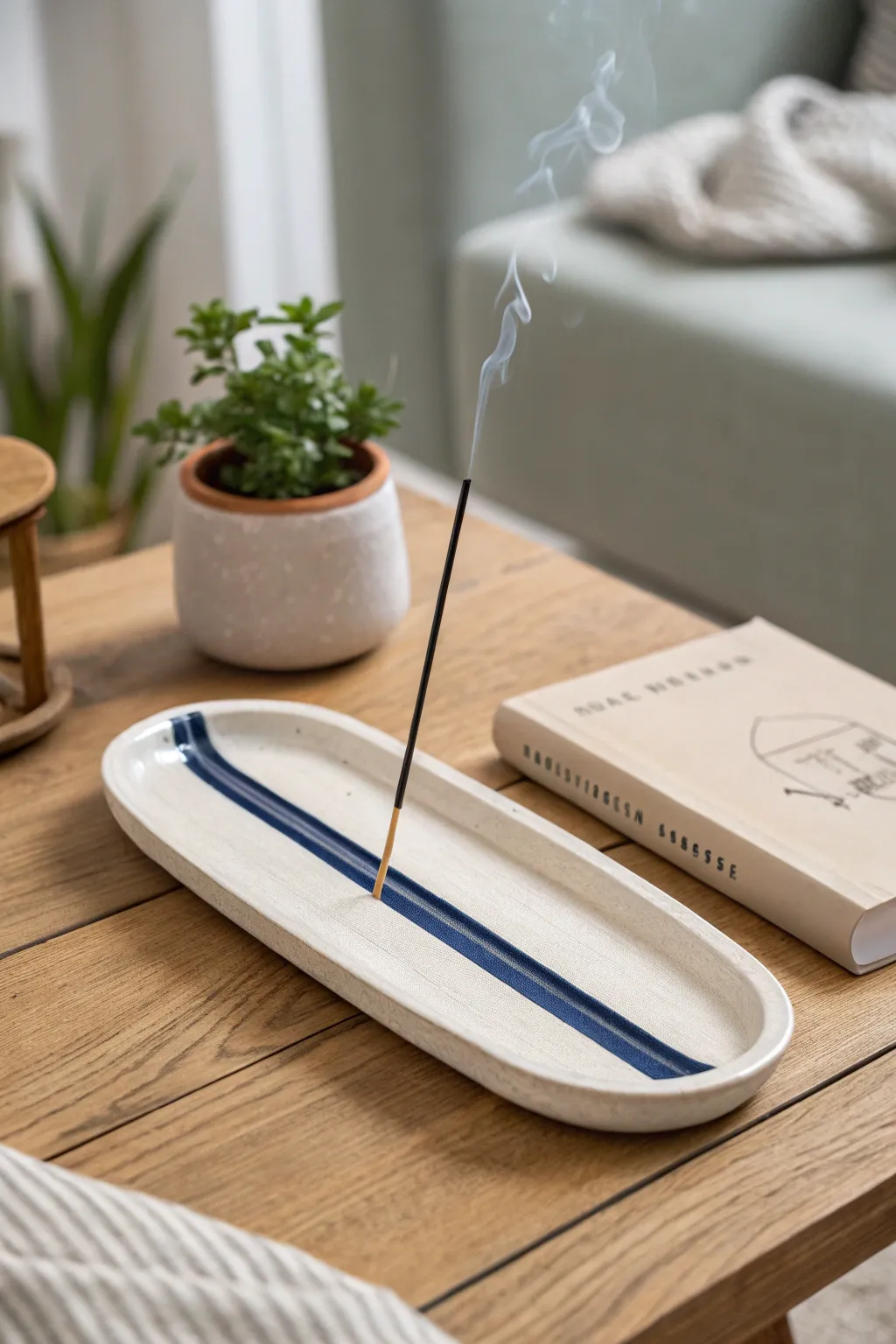 Minimal oval clay incense holder with long ash groove, Scandinavian calm with a bold cobalt pop.
