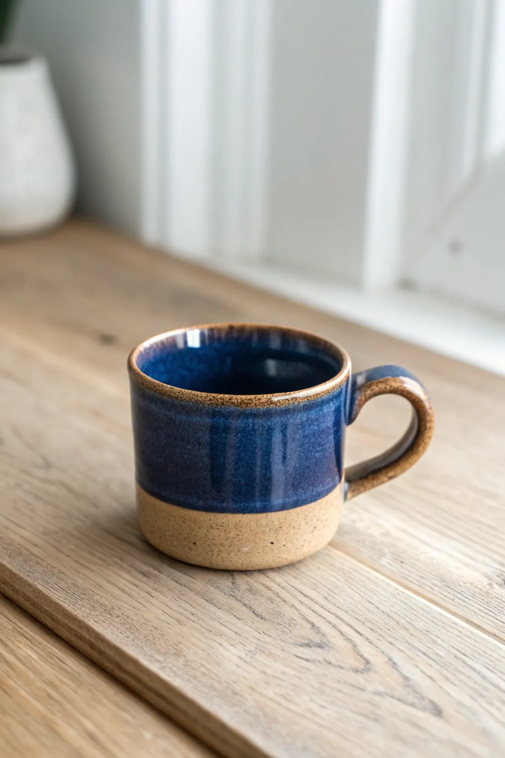 Tiny one-finger loop handle on a glossy espresso mug, minimal design with bold contrast.
