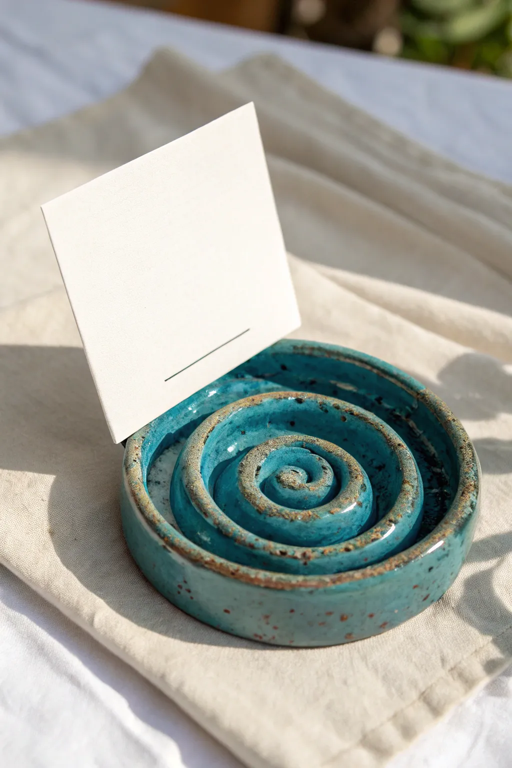 Swirled coil clay groove stand with bold color and clean lines for displaying photos beautifully.