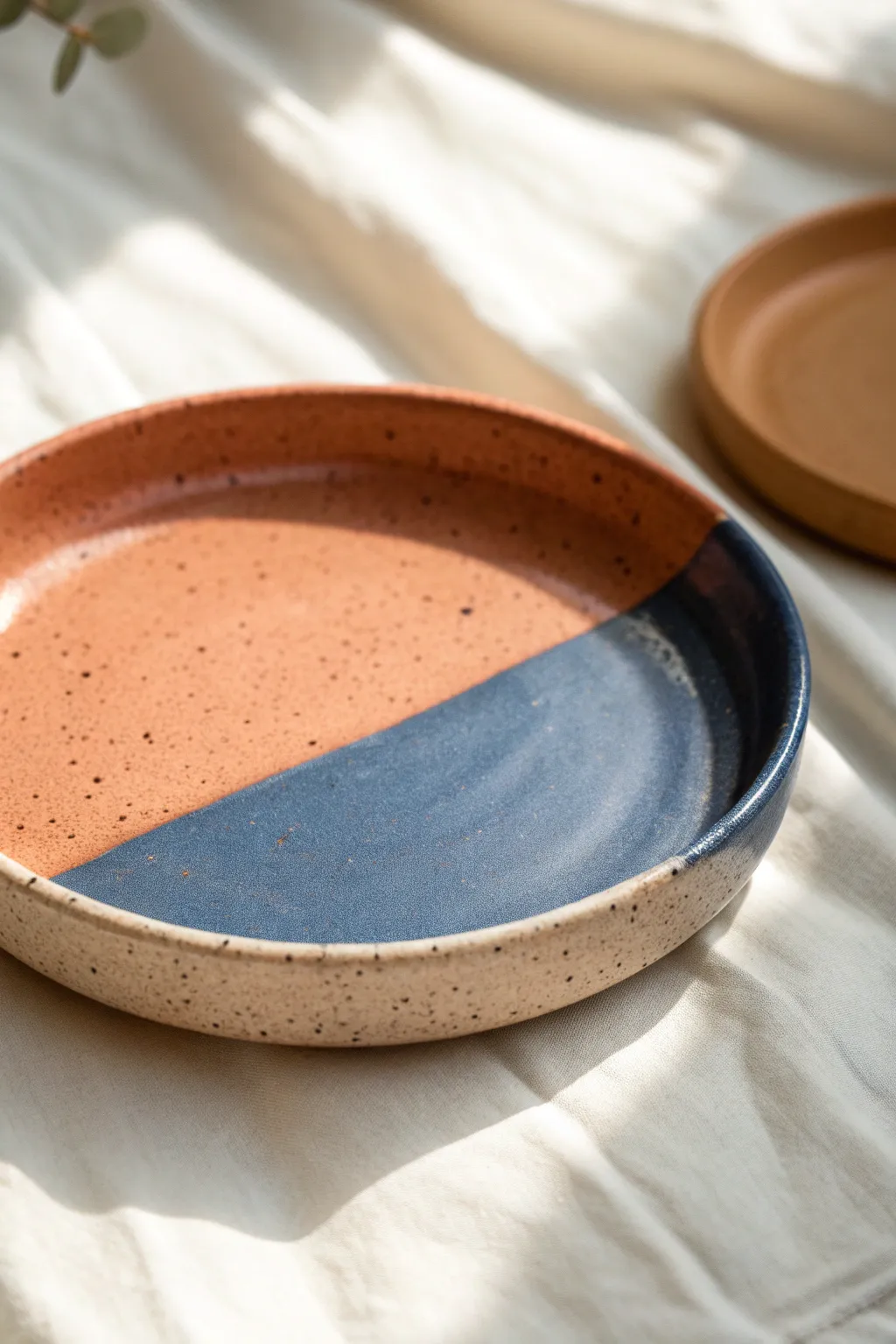 Bold two-tone dip-color clay plate in blush and cobalt, minimalist, modern, and handmade.