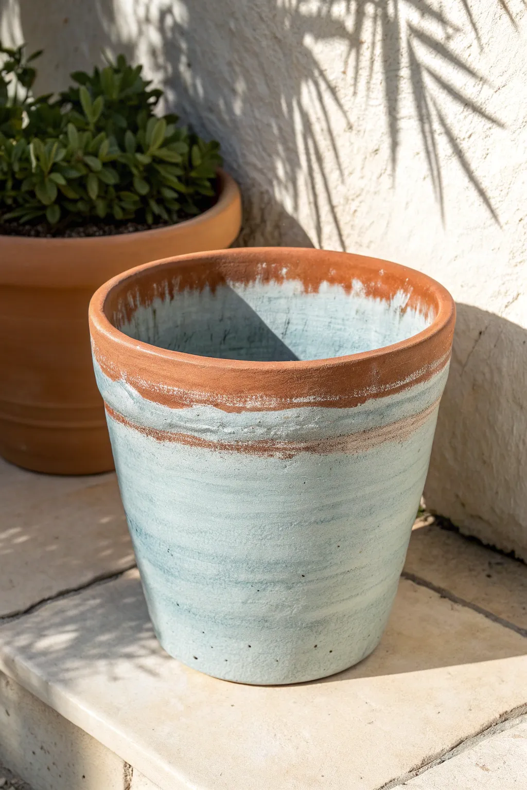 Terracotta peeking through a dusty blue wash tint, simple Scandinavian styling with boho warmth.