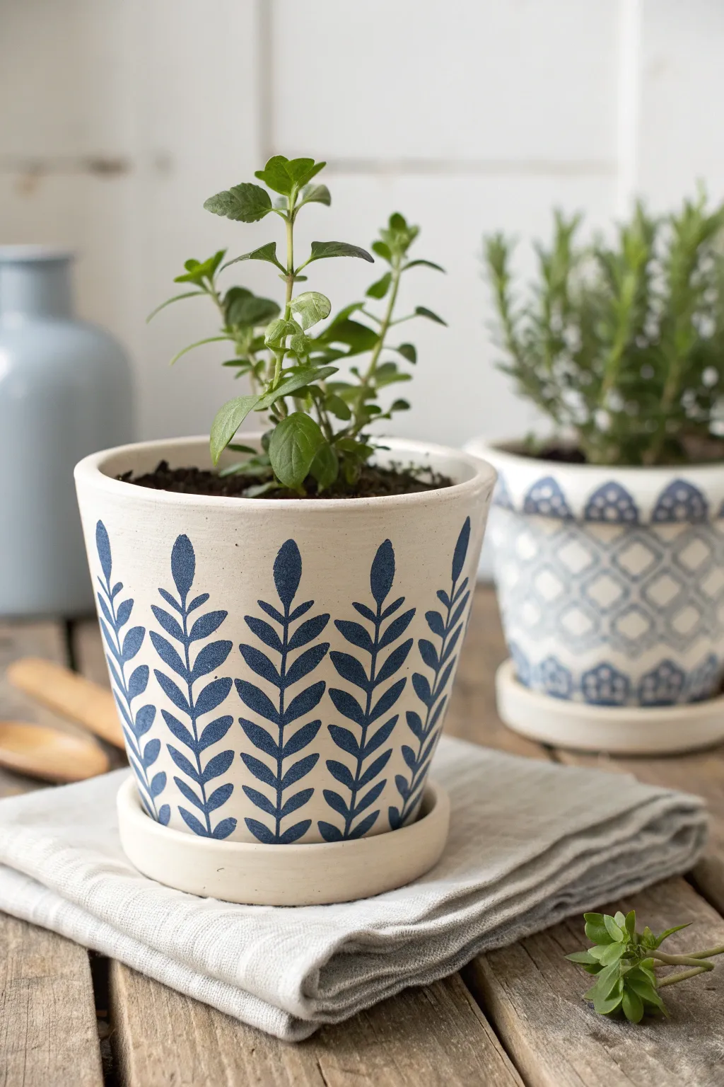 Crisp stencil arches turn a simple clay pot into a modern boho herb planter set