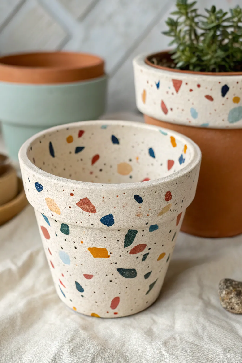 Terrazzo-speckled clay pot with bold color flecks, minimalist Scandinavian look with boho warmth.
