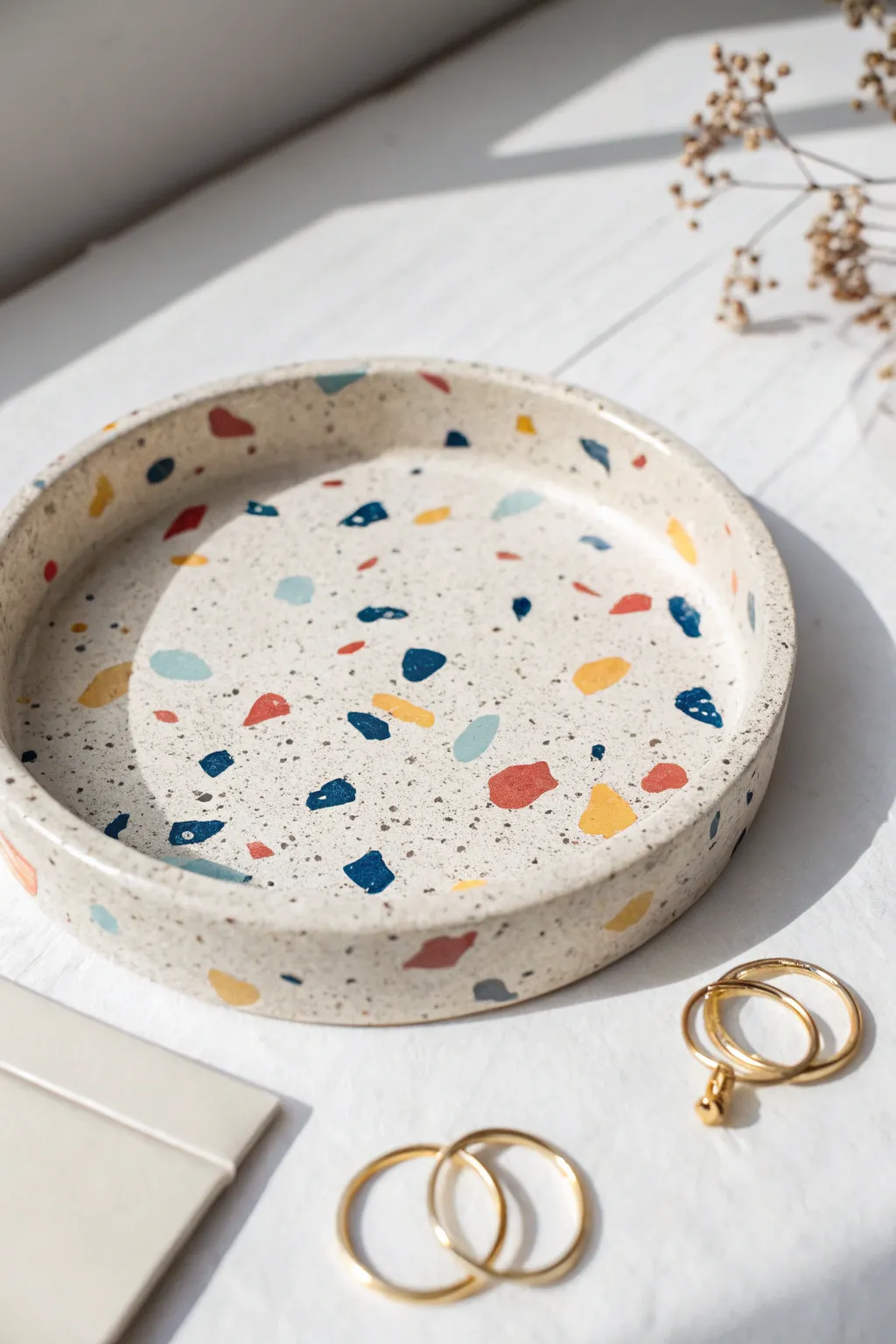 Terrazzo-speckled clay tray in bold colors, a chic minimalist catchall for rings and clips.