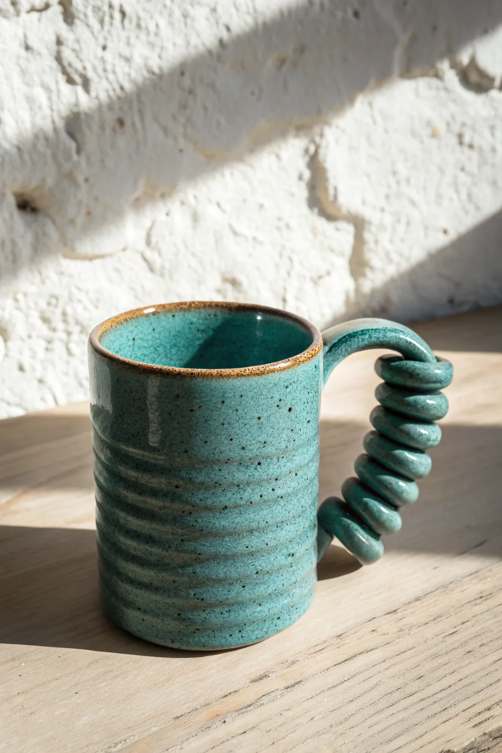 Chunky coil handle mug with satin glaze and rustic seams, simple yet bold for cozy mornings.