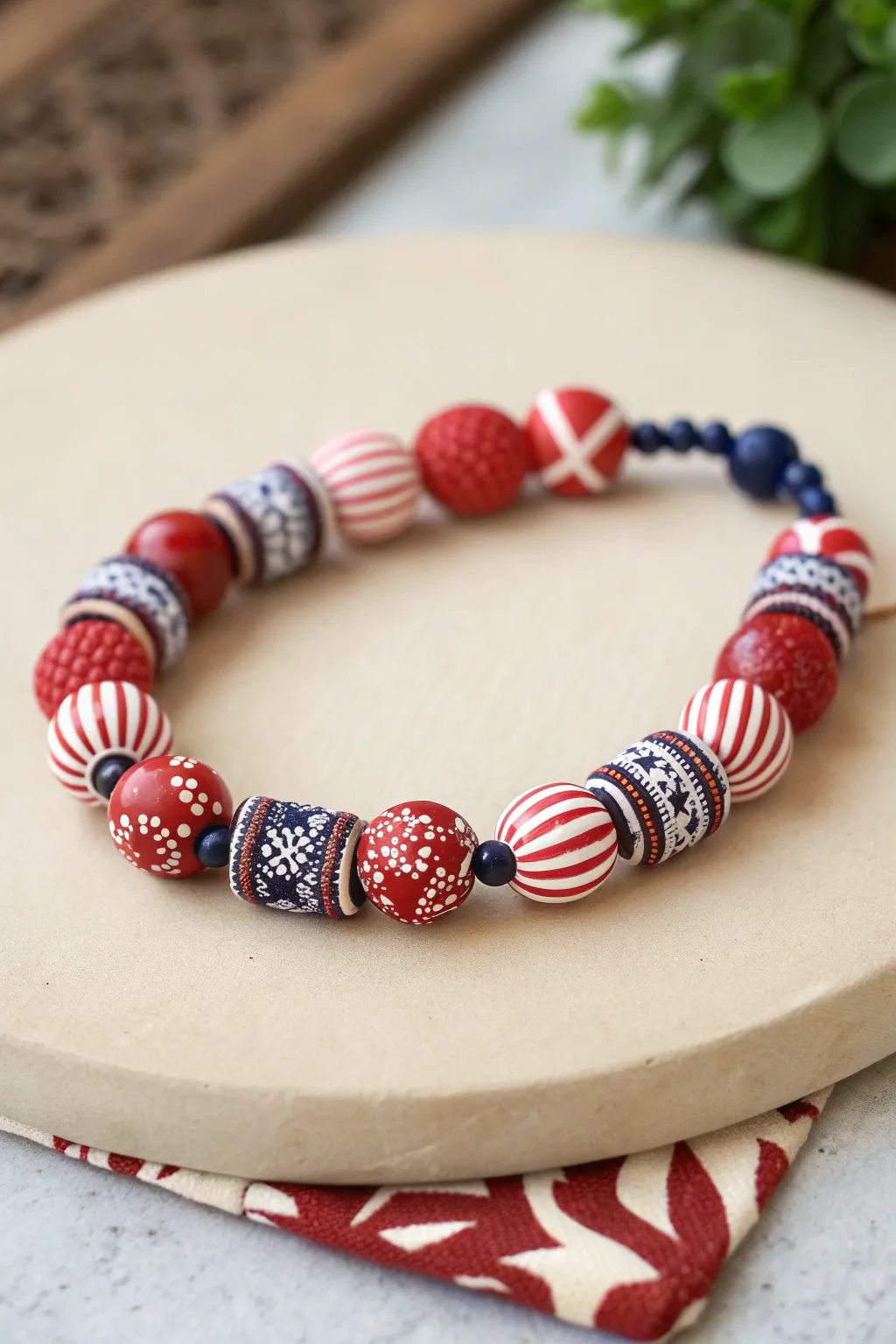 Bandana-inspired clay bead bracelet in red and white stripes with a tiny navy pop, country chic