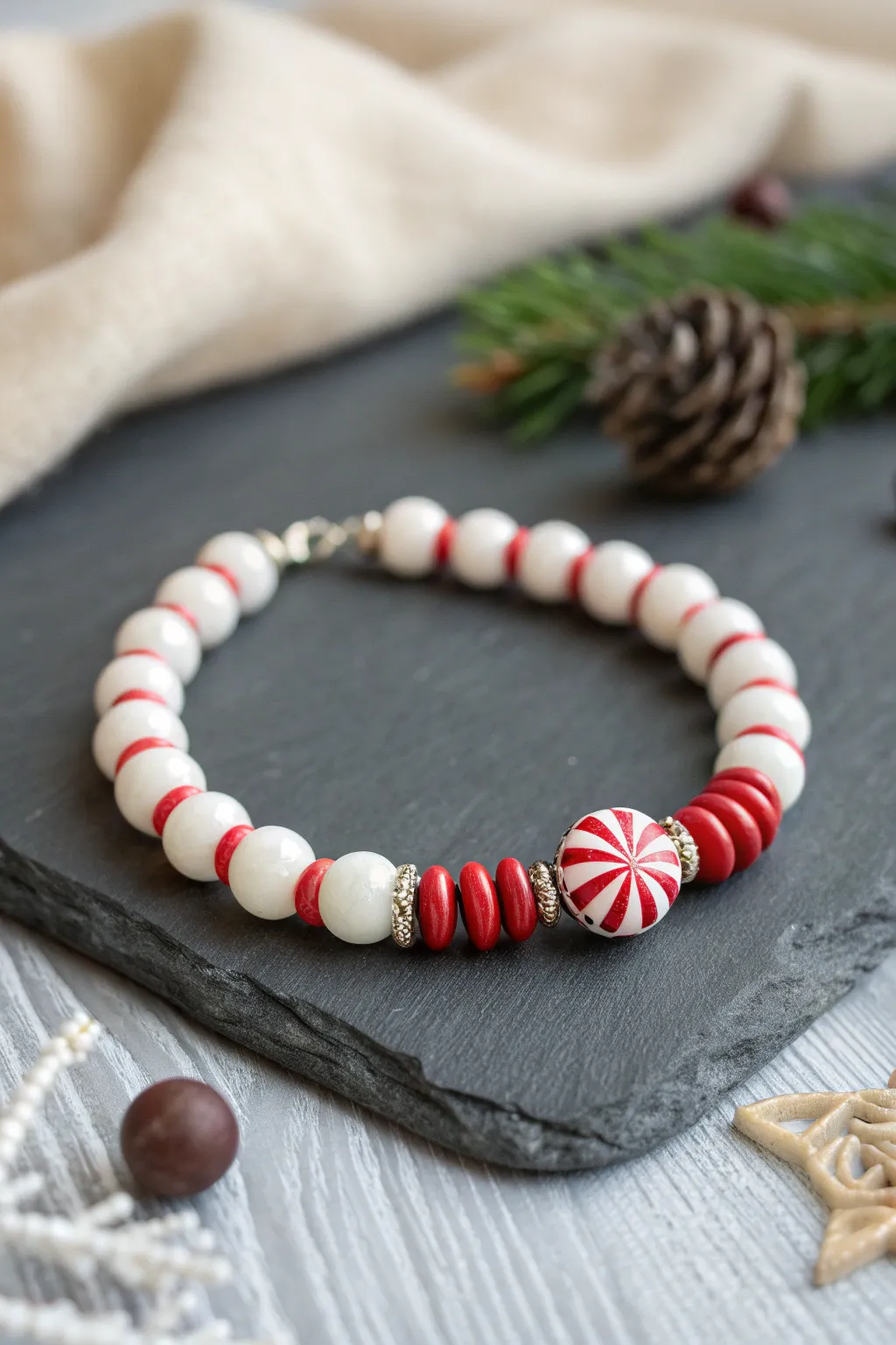 Peppermint swirl focal bead bracelet in red and white, a cozy minimalist Christmas pop.