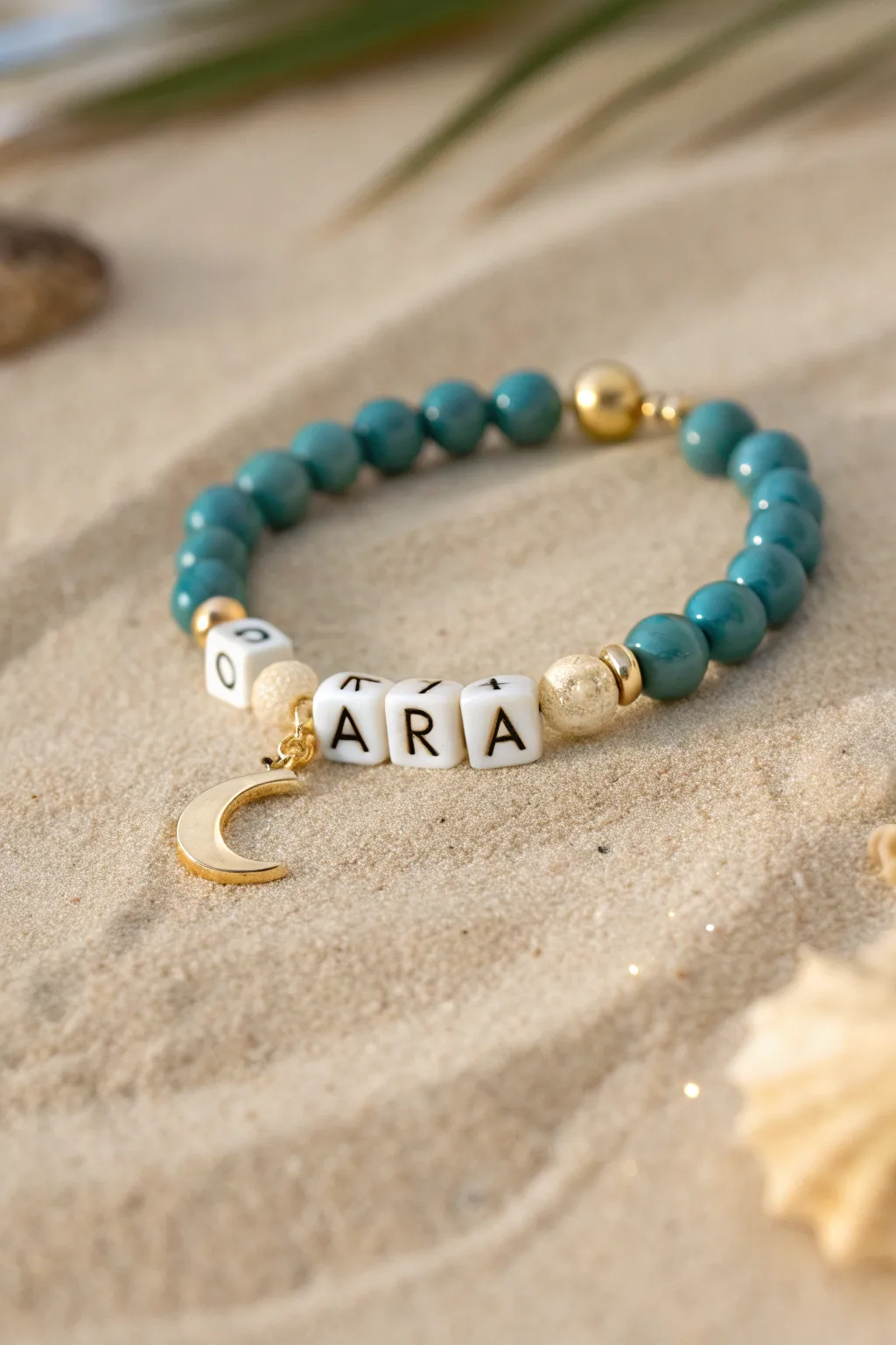 Desert-princess teal and gold clay bead bracelet with a tiny crescent moon charm and name strand