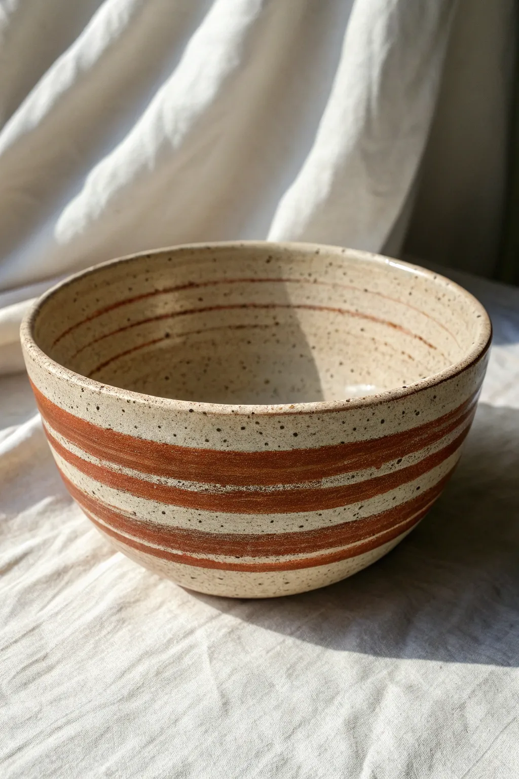 Drape-molded bowl with bold textured stripes and a clean smooth rim for crisp contrast.