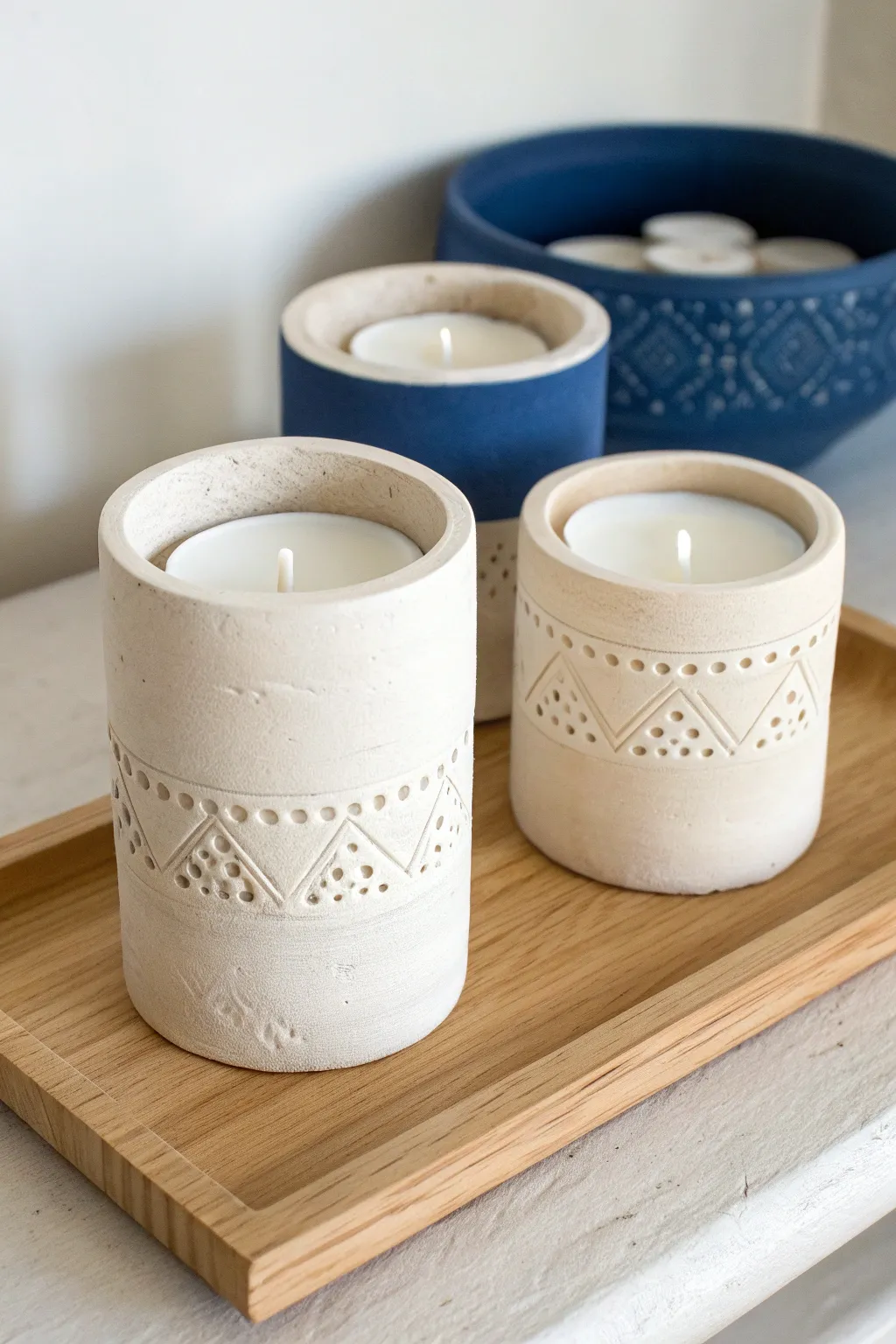 Minimal air-dry clay tealight holders with simple texture for a cozy Scandinavian-boho shelf