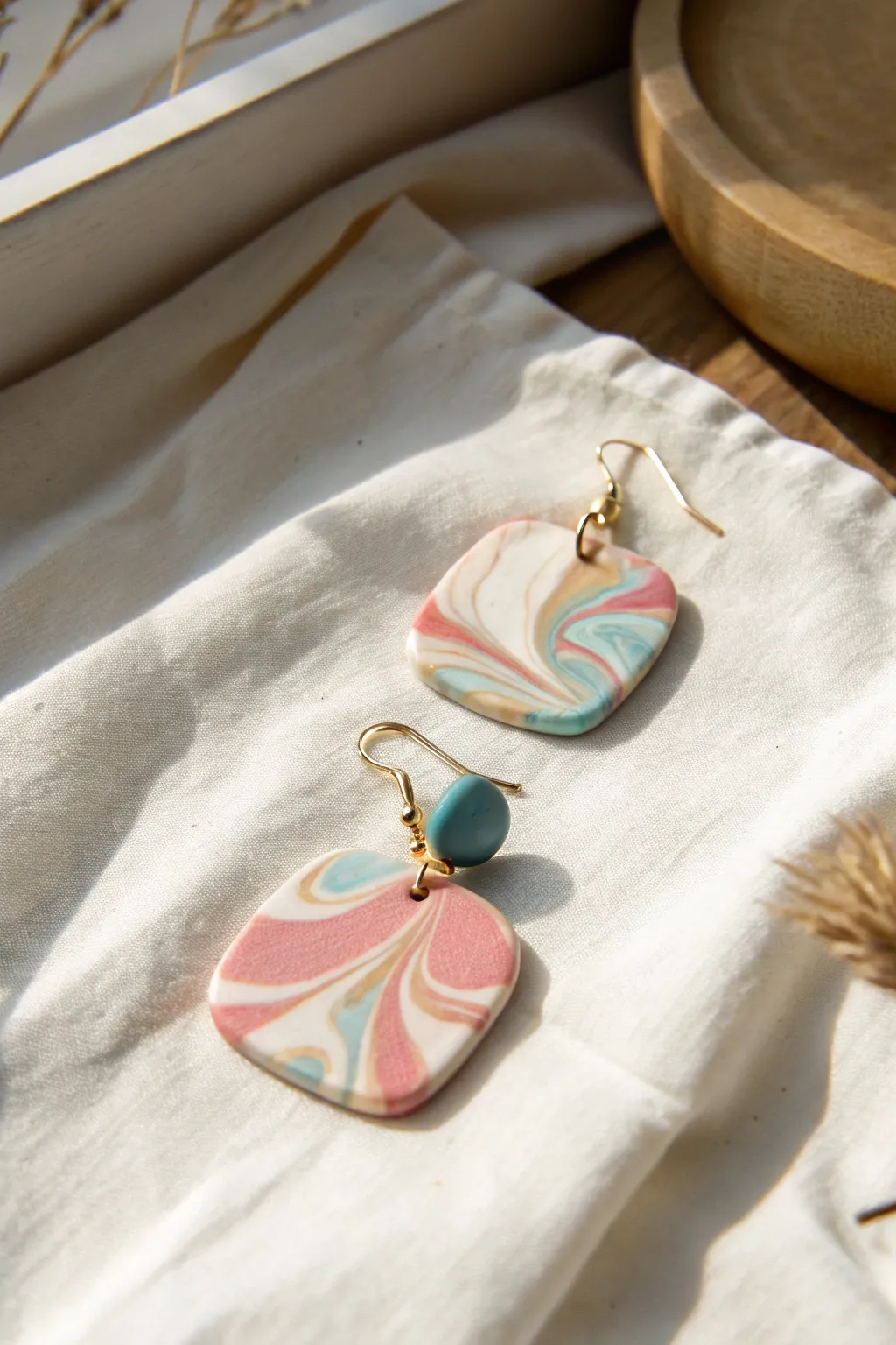 Soft marble swirl dangles in blush, ivory and teal, a simple DIY clay earring look.