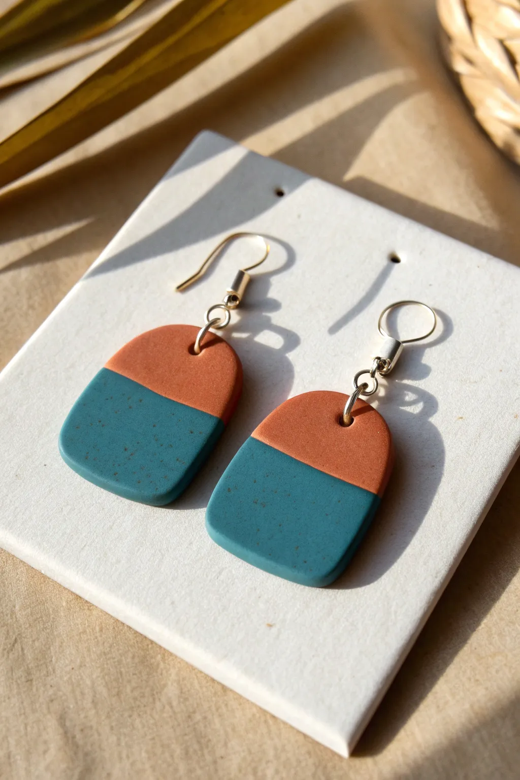 Two-tone polymer clay tab earrings with crisp color blocking, minimalist style, bold modern contrast