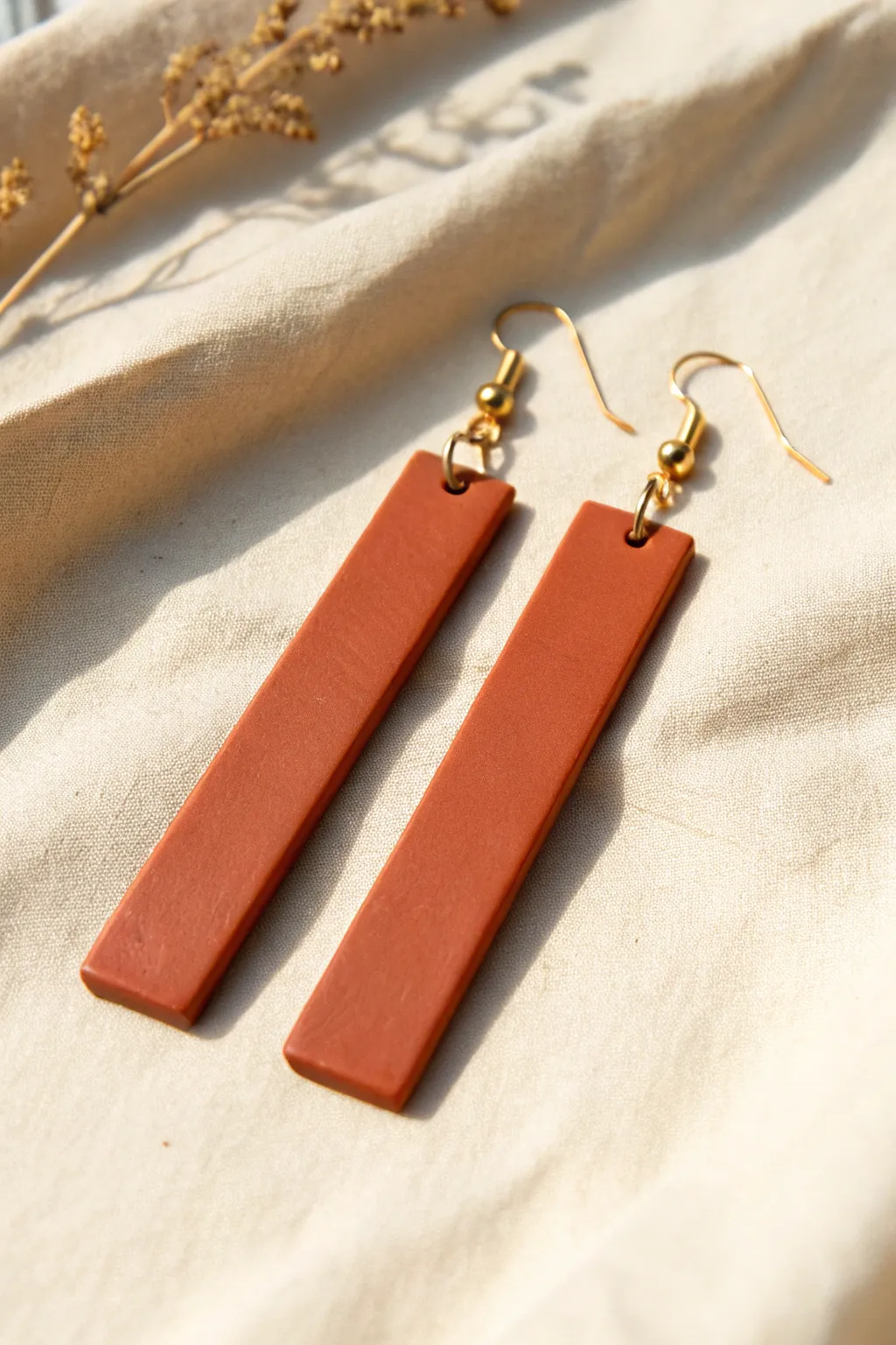 Minimal polymer clay bar drop earrings in bold terracotta, clean lines and modern boho charm.