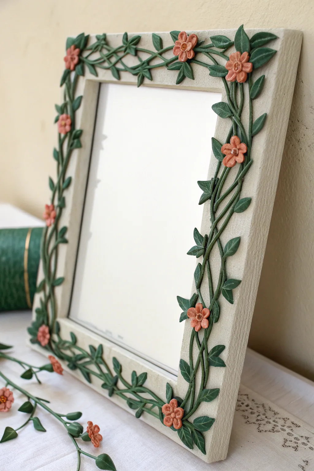 Minimal foam clay vine mirror with bold leafy corners for an airy Scandinavian boho look