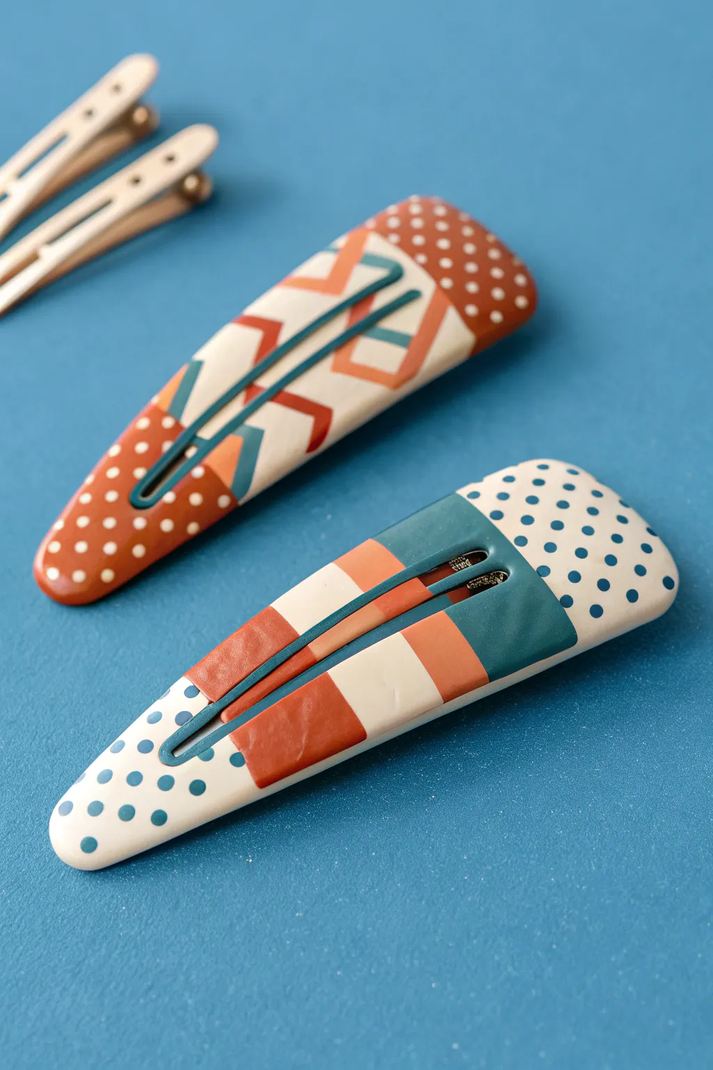 Playful patterned polymer clay hair clips in bold colors, minimalist Scandinavian vibe.