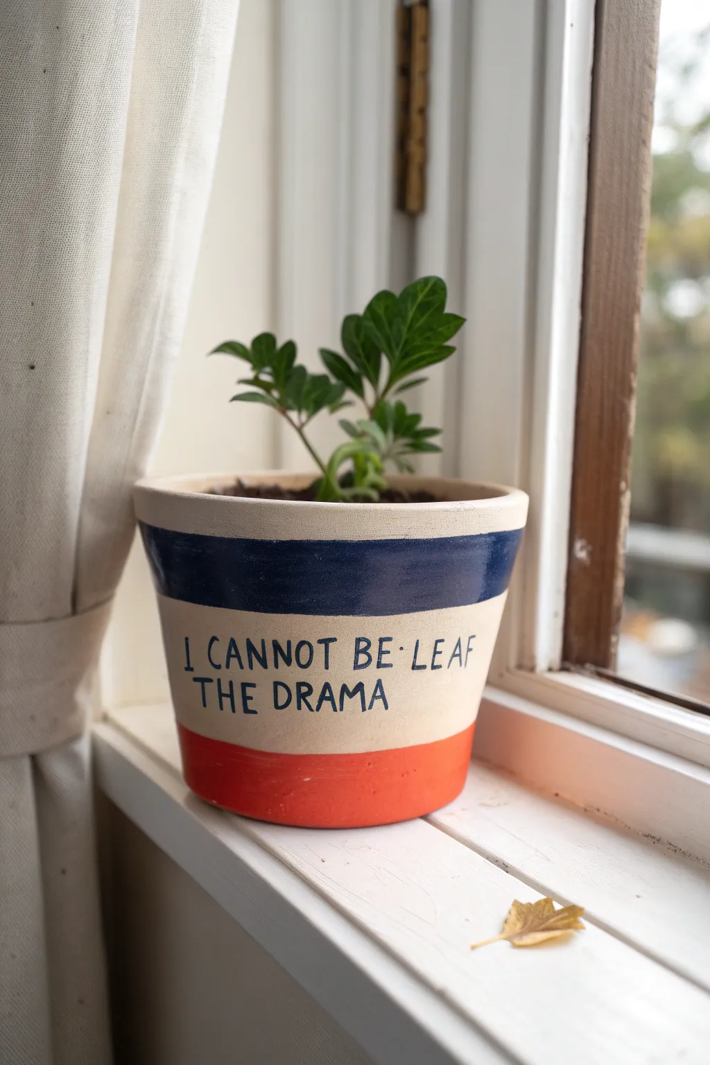 Drama-queen plant pot with a bold pun and sassy leaf doodle, styled on a bright windowsill.