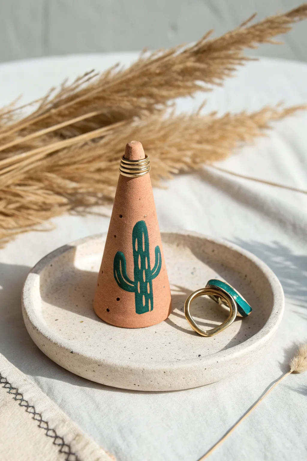 Handmade clay ring holders: minimalist cone and cactus on one base, bold boho hues.