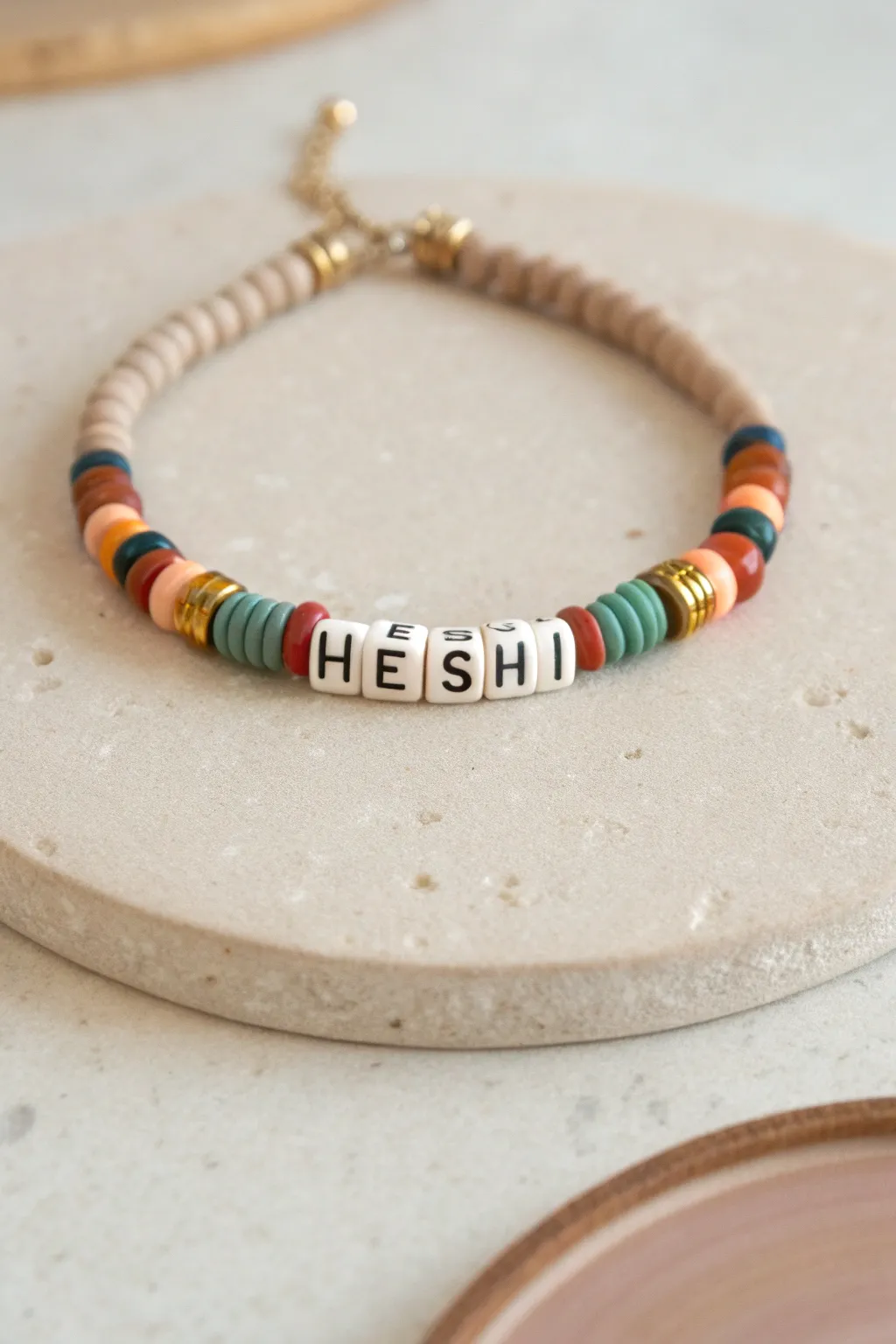 Minimal heishi bracelet with centered name beads and bold symmetrical color blocks for inspo