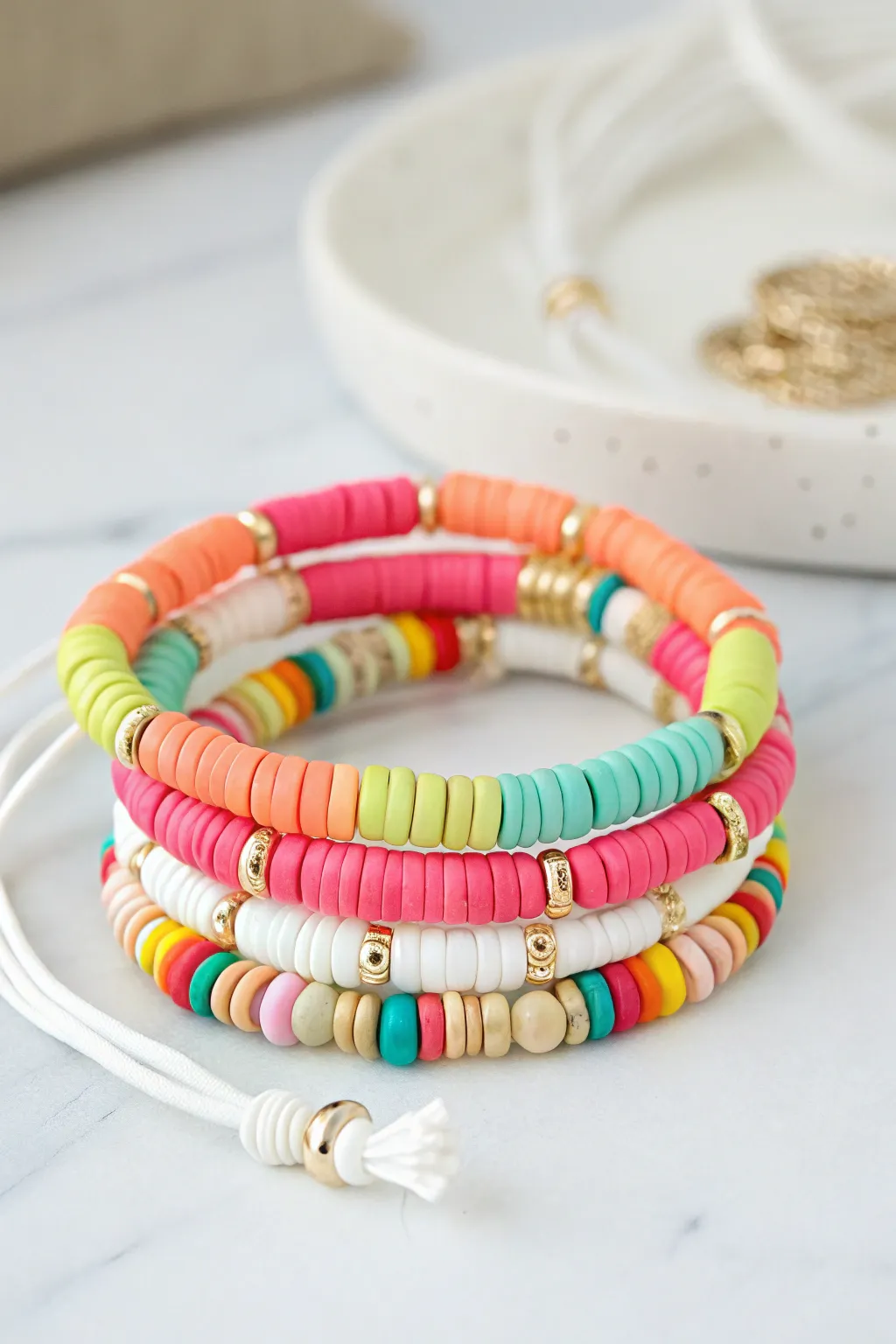 Confetti heishi clay bead bracelet stack with crisp white accent, bright, playful, easy DIY.