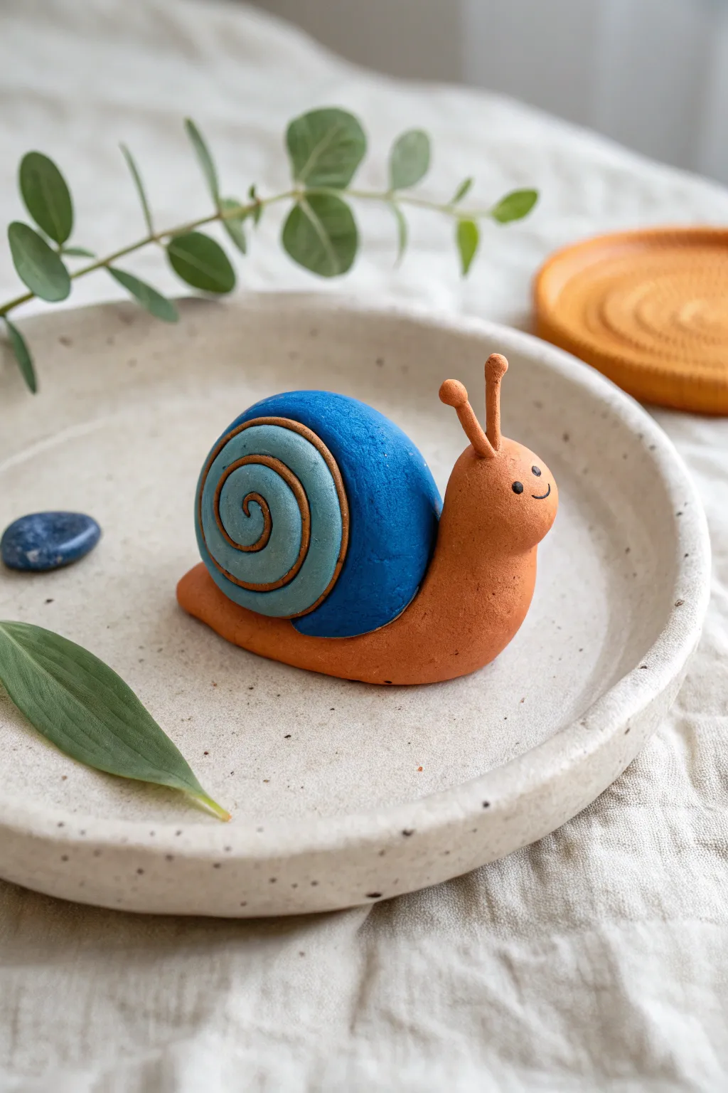 Beginner-friendly air dry clay snail with a bold swirl shell, styled in minimalist boho calm.