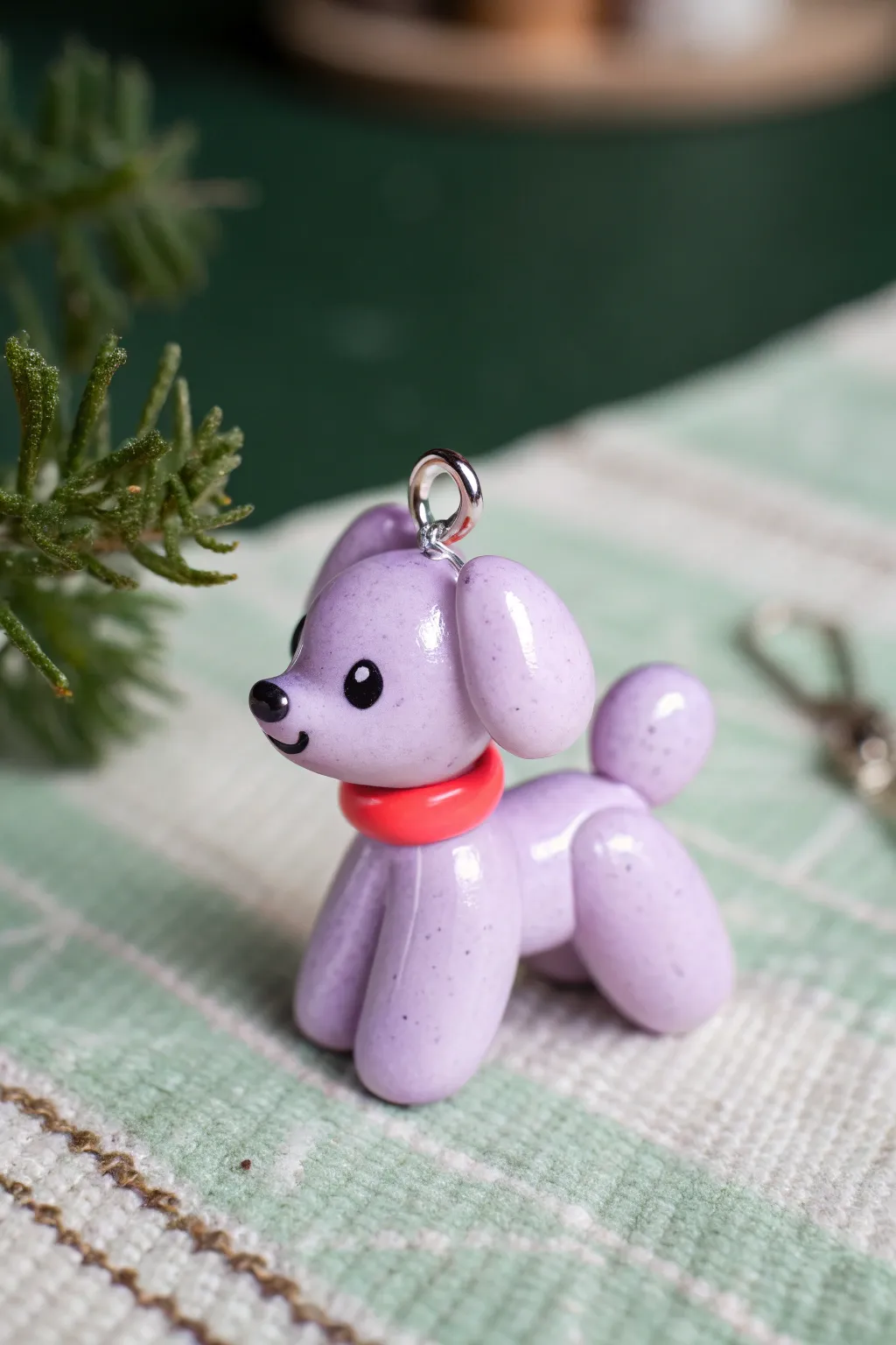 Pastel polymer clay balloon dog charm with a tiny kawaii face, minimal and irresistibly cute.
