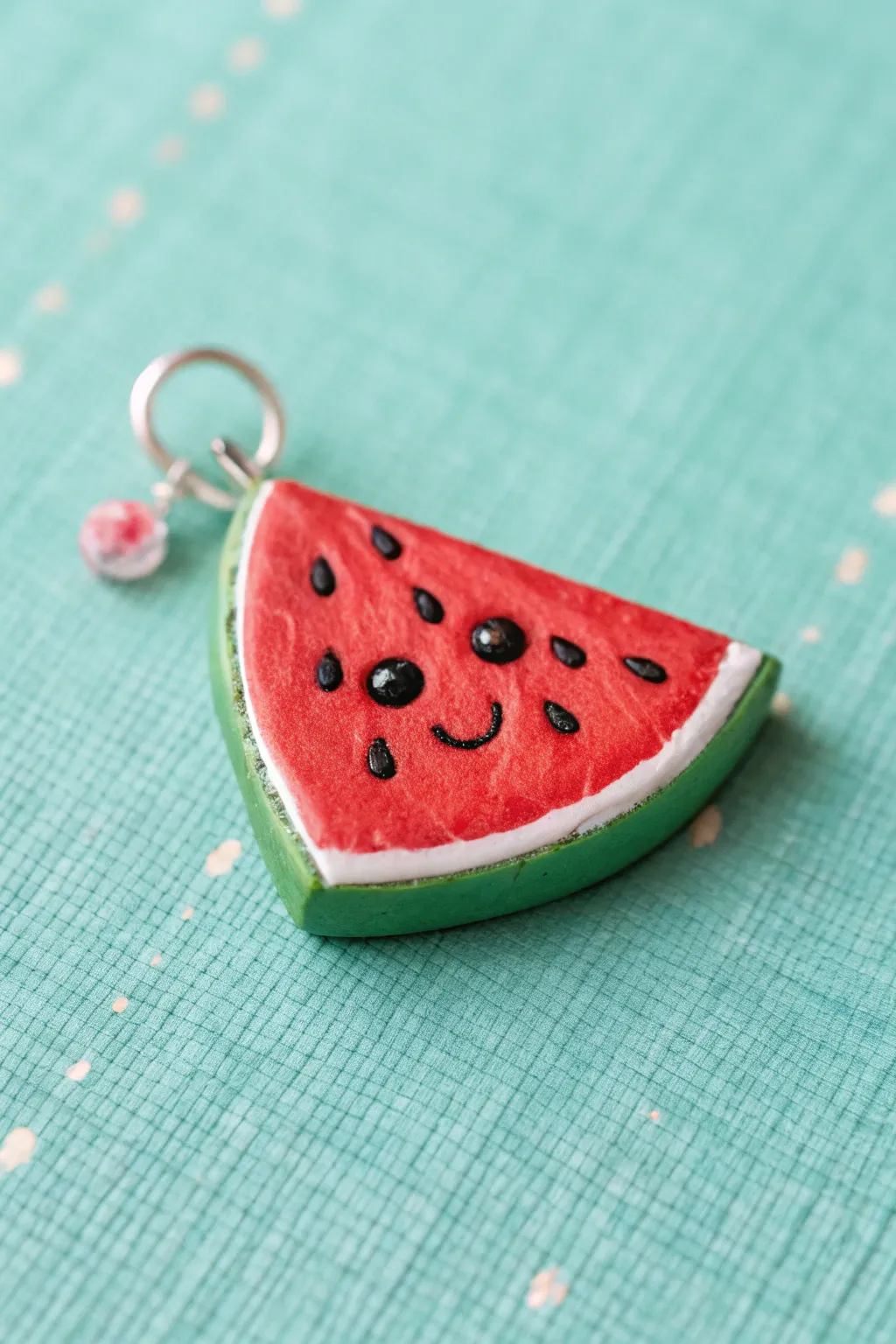 Mini clay watermelon slice with blush cheeks, a sweet beginner project in bold summer colors
